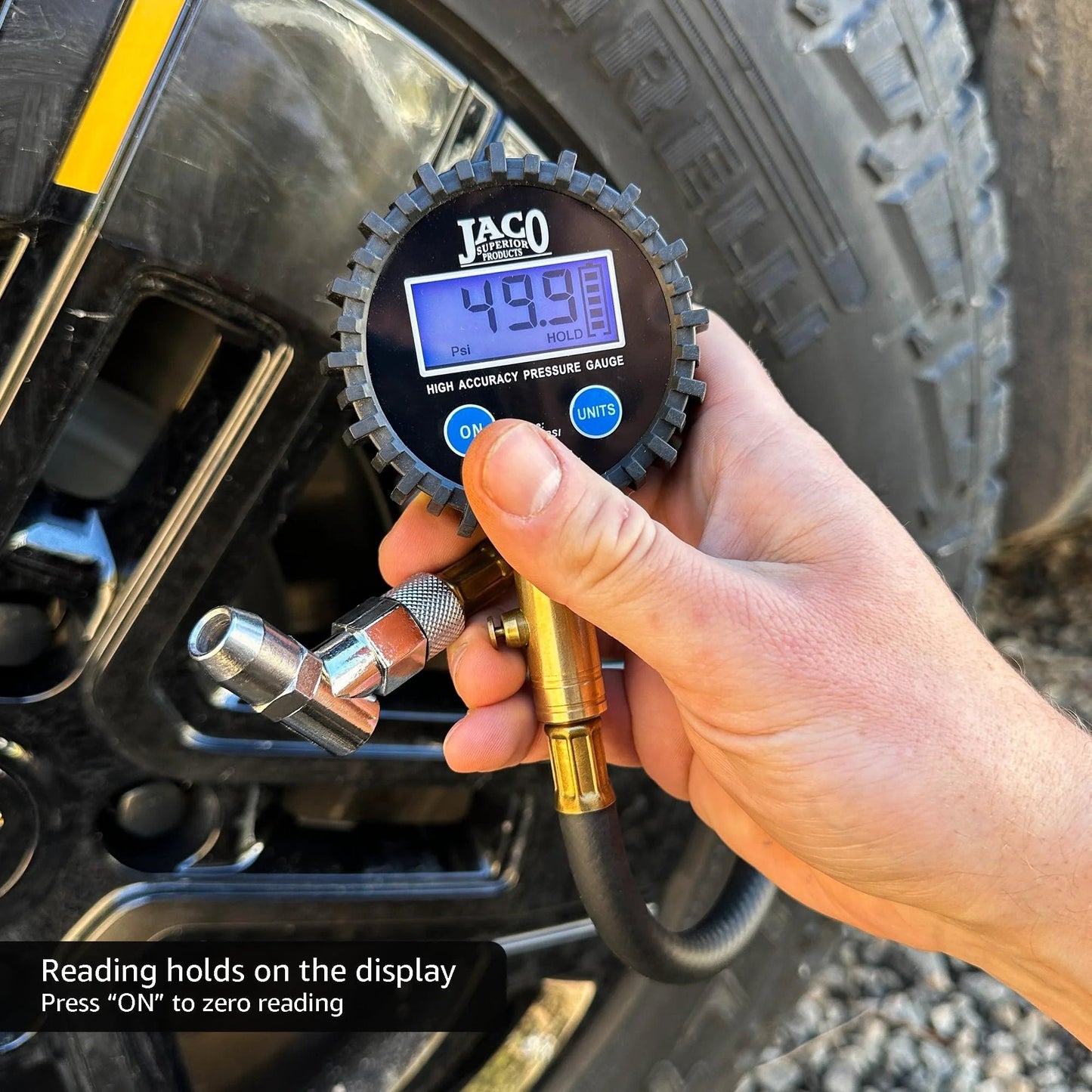 Hand using ElitePro Digital Tire Pressure Gauge Pro Grade Accuracy Up To 100 PSI With Dual Sensors on a vehicle tire