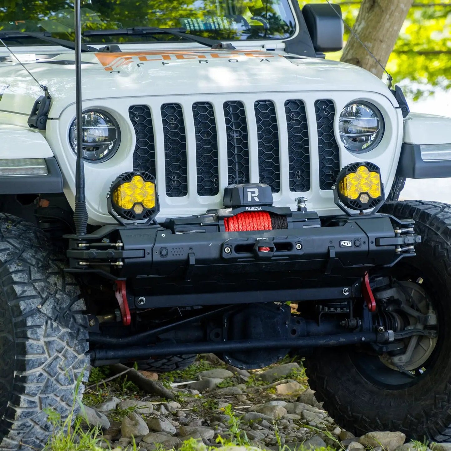 Beast 13500Lb Waterproof Electric Winch With Synthetic Rope 12V For Truck And SUV Hawse Fairlead 2 In 1 Infrared Remote And Wired Control Red Rope Off Road Ready installed on a Jeep front view.