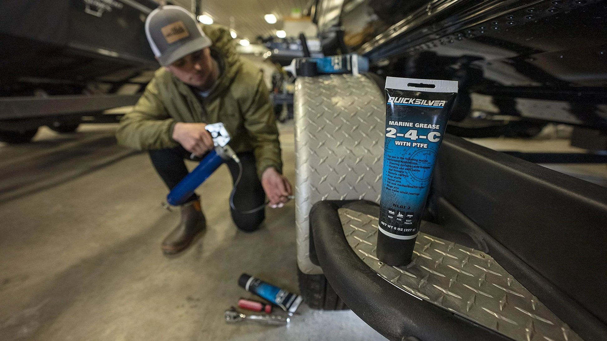 Image of 2-4-C Marine Grease With PTFE Teflon For Boats And Cables, Multi Purpose Lubricant tube, in a boat garage.