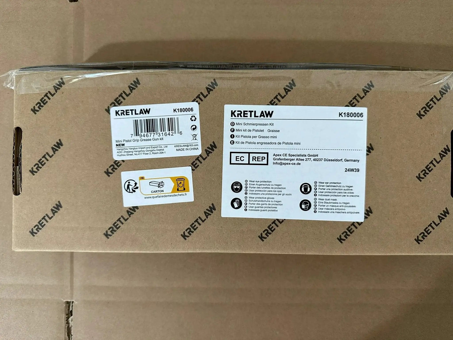 Box labeled Kretlaw, containing the Mini Grease Gun Kit 3000 PSI With Double 3oz Cartridges And 12 Inch Flex Hose Pro Grade