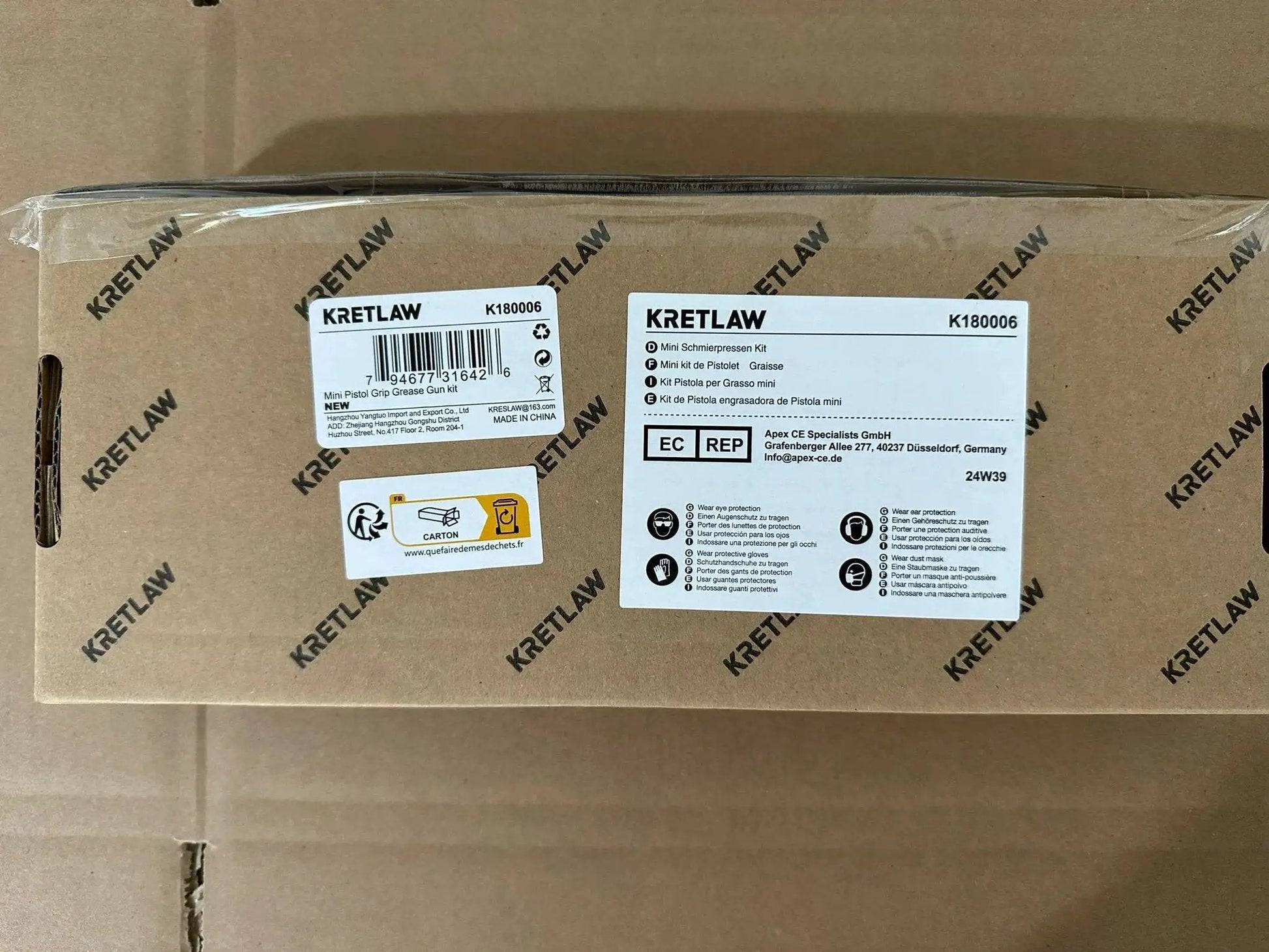 Box labeled Kretlaw, containing the Mini Grease Gun Kit 3000 PSI With Double 3oz Cartridges And 12 Inch Flex Hose Pro Grade
