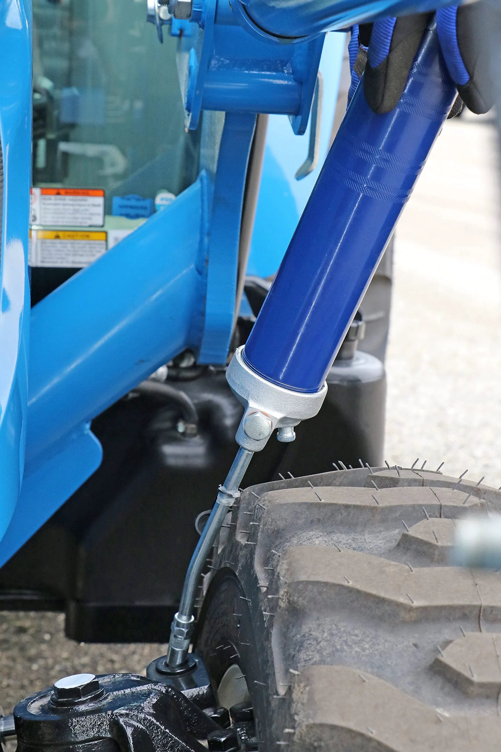Heavy Duty Lever Action Grease Gun From Lincoln With Cast Iron Pump Head 10000 PSI Max Fits 14.5 Oz Cartridges Or 16 Oz Bulk Includes 6 Inch Extension And Hydraulic Coupler For Auto Farm And Industrial Use in use on machinery
