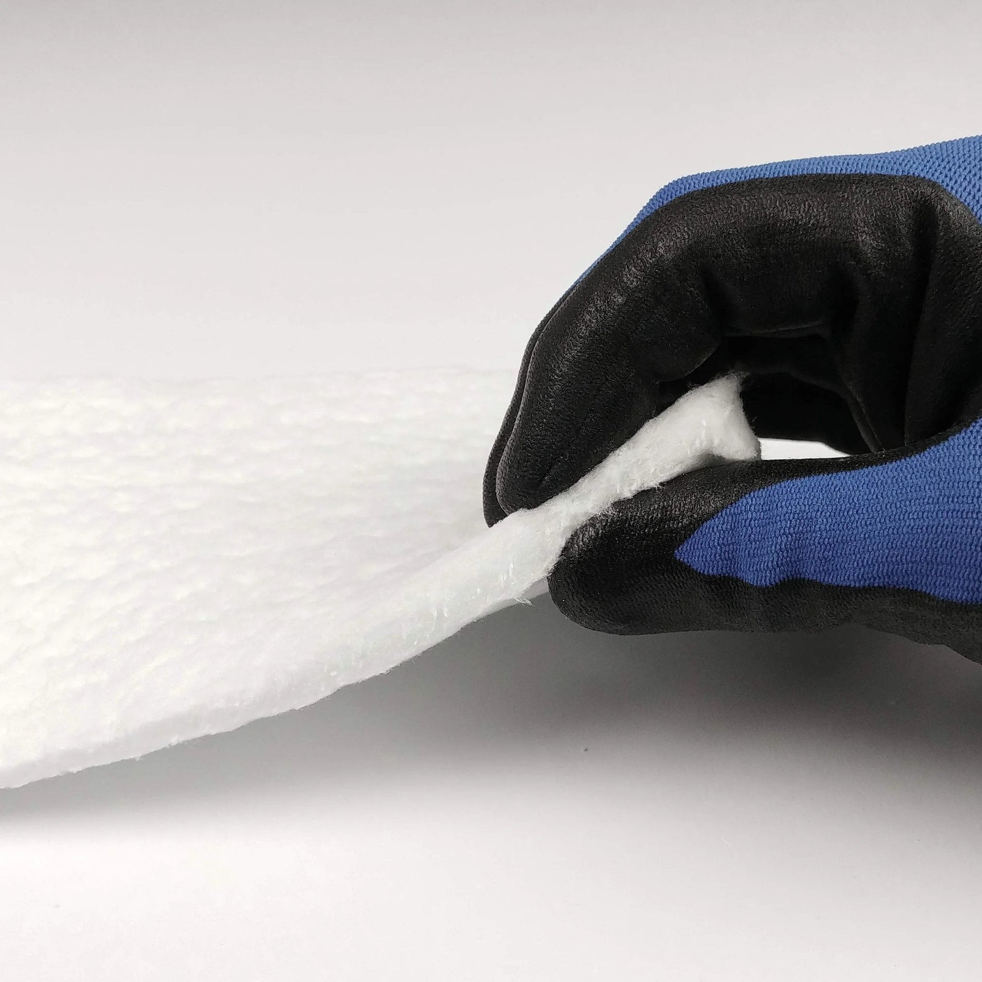 Close-up of Ceramic Fiber Insulation Blanket Heavy Duty One Quarter Inch Thick 16 Inch By 48 Inch 2400F Fireproof Shield being held in hand