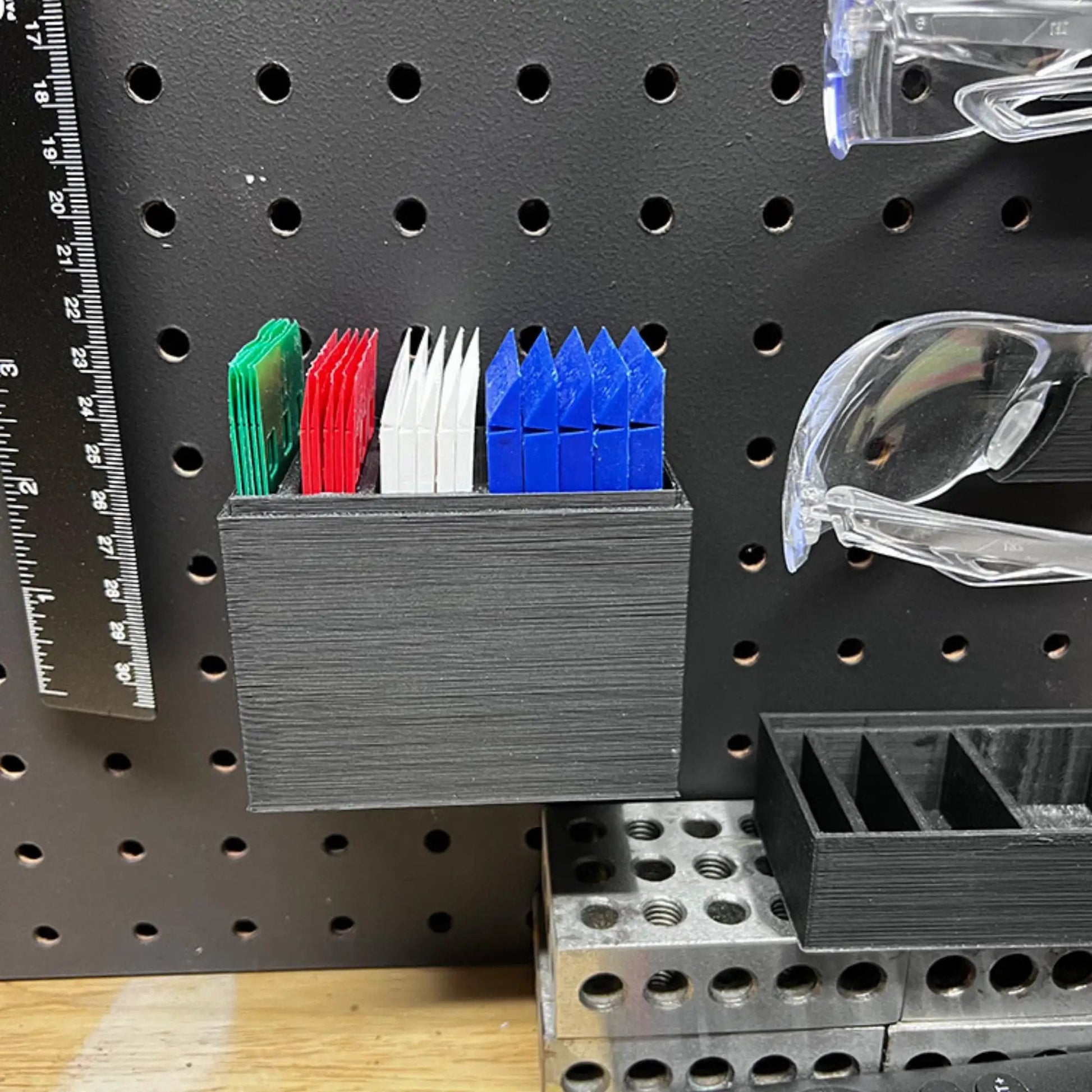 Heavy Duty Reusable Plastic Construction Shims For Spacing And Leveling Great For DIY Projects And Plumbing 40 Piece Pack One Eighth Inch White Handi Shim in assorted colors on pegboard.