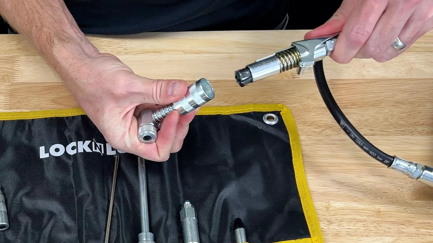 8 Piece Quick Connect Greasing Accessory Kit For Reaching Every Fitting On Any Machine With A Ripstop Case That Keeps Tools Clean And Portable Pro Grade Gear By LockNLube in use with a hose.