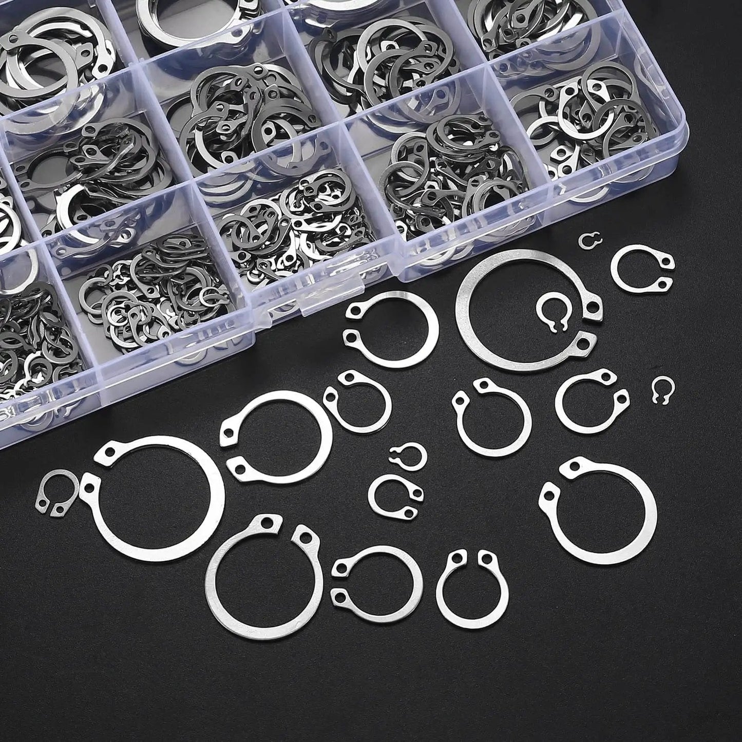 300 Piece Retaining Ring Set With Internal And External Snap Rings In Stainless Steel Circlip Retention Rings 18 Size Assortment For Grooved Shafts Pins And Studs Durable Rust Resistant And Easy To Use displayed in a box and scattered outside