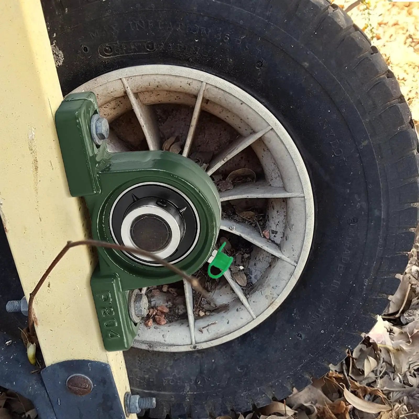 Installed Eight Pack Pillow Block Bearings UCP20412 Three Quarter Bore Self Aligning Ball Bearings in cast iron housing on equipment wheel.