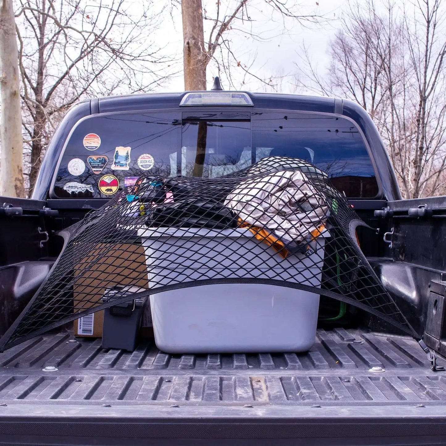Elastic Cargo Net For Truck Bed And SUV Keeps Lightweight Loads In Place Without Tying Simple Mesh Organizer Fits All Trucks Vans ATVs UTVs SUVs From 4x4 To 7x7 Feet Black securing items in a truck bed.