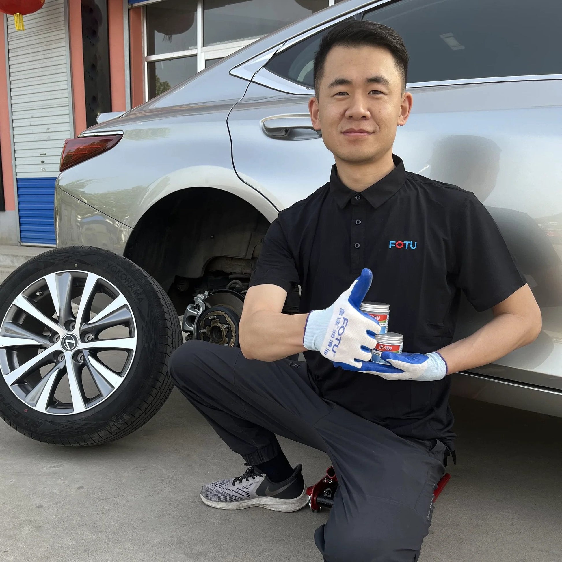 Mechanic with High Temperature Resistant Brake Caliper Guide Pin Lubricant For Smooth Braking And Long Lasting Performance Heavy Duty Suitable For Most Vehicles By FOTU 661 near car wheel.