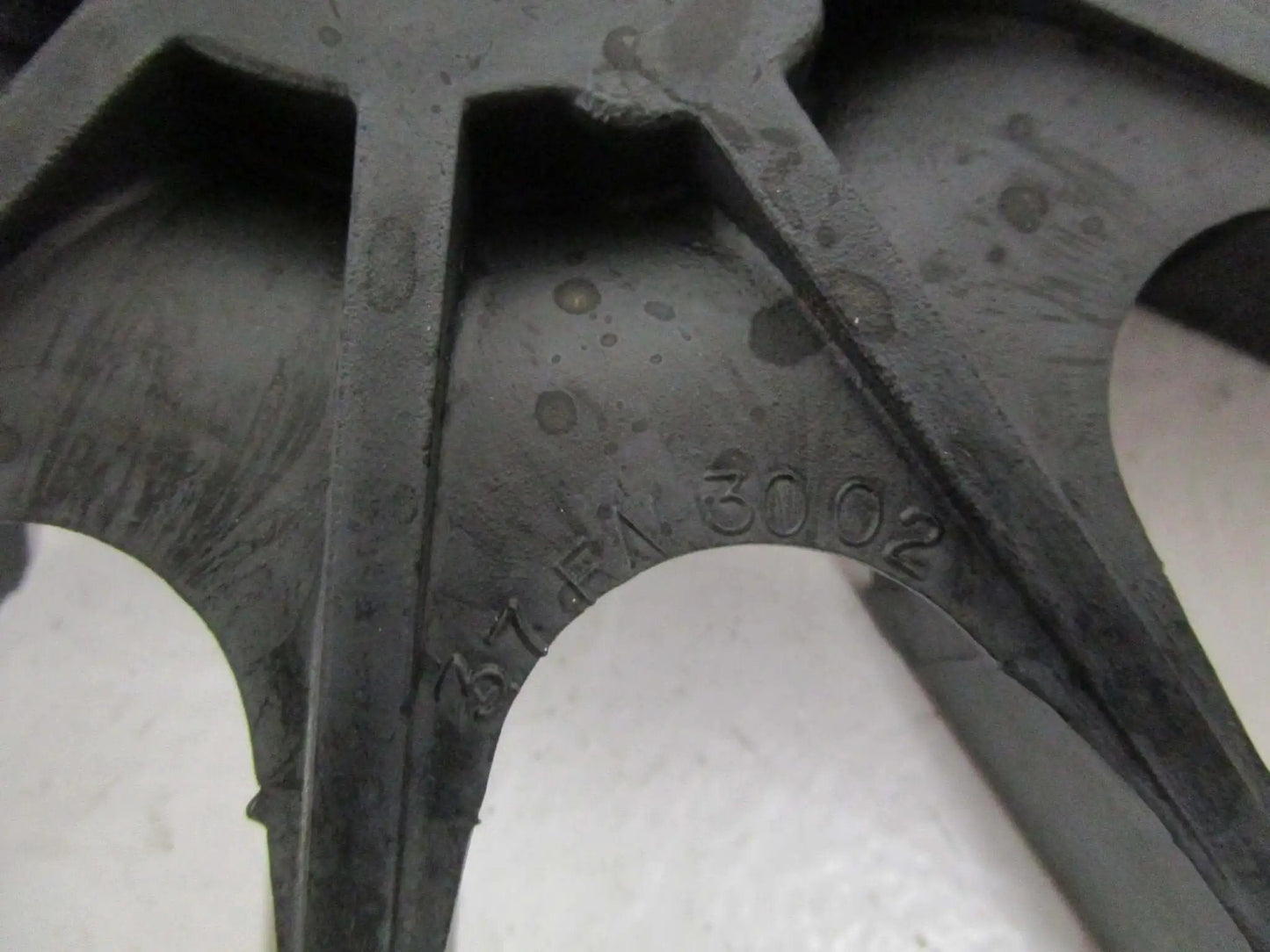 Close-up of 37FN3002A01SP EXFN plastic bearing sleeve with visible part number, showcasing precision fit design detail.