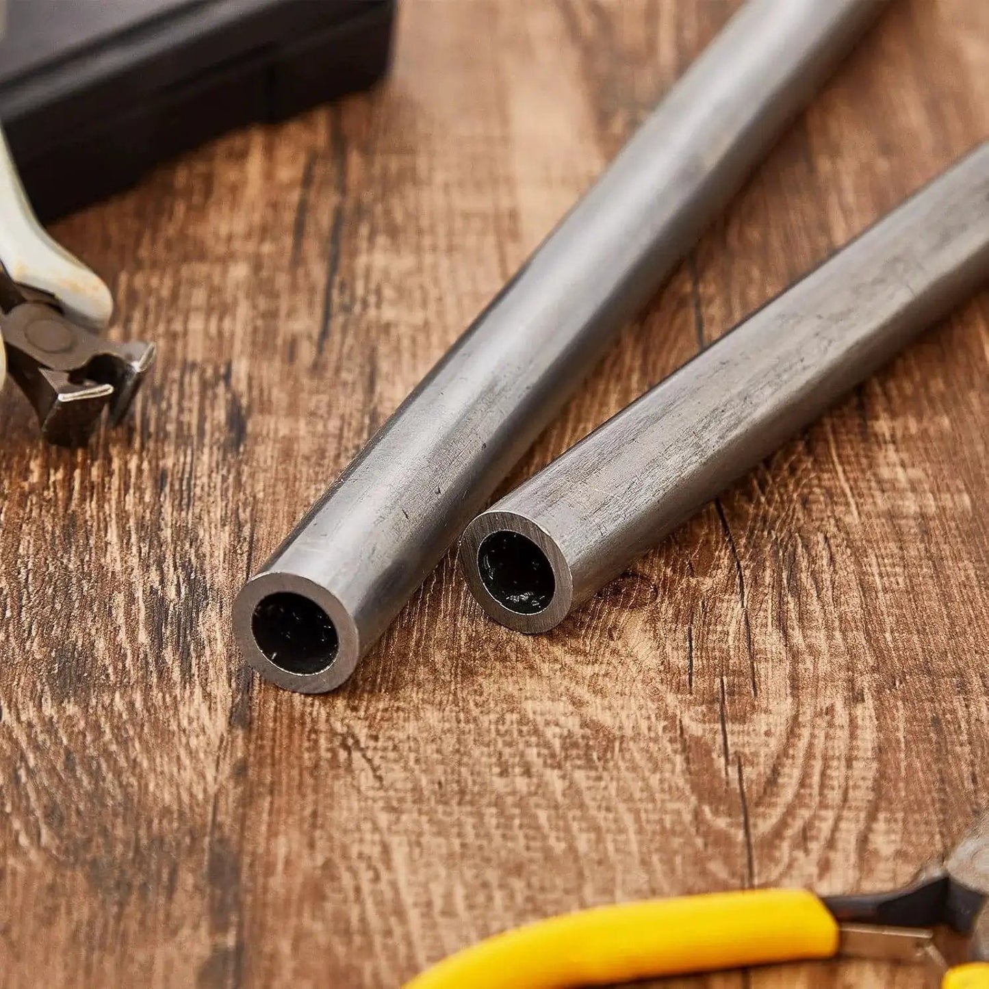 Two Pack Three Quarter Inch Cold Rolled Steel Tubes Seamless Round Tubing Heavy Duty Built To Last 6 Inch Length on wooden table