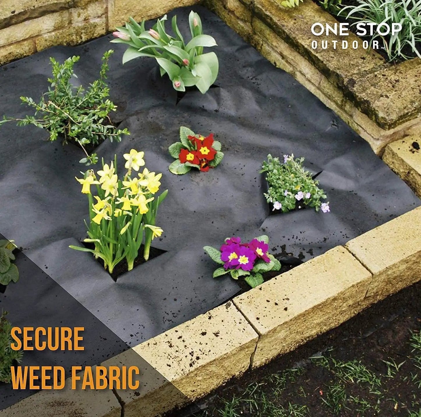Flower bed with black weed fabric, secured with edging stakes, flowers planted through fabric, brick border visible.