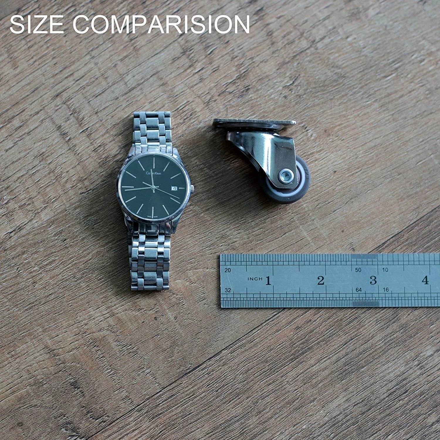Size comparison of a watch and a 1" low profile swivel caster wheel on wooden surface.