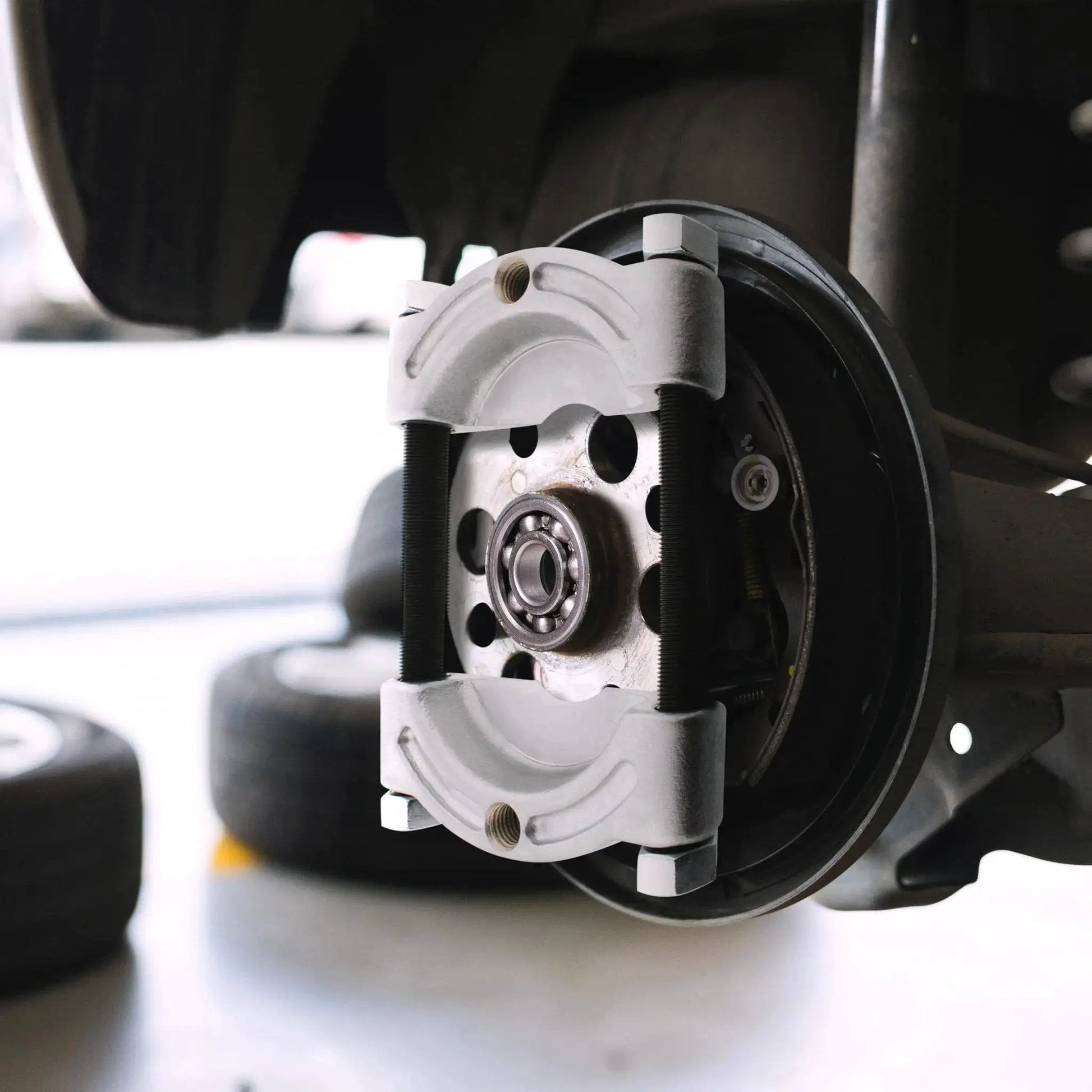 Bearing Puller Kit 14 Piece 5 Ton Automotive Bearing Separator with 2 and 3 Inch Jaws installed on wheel hub