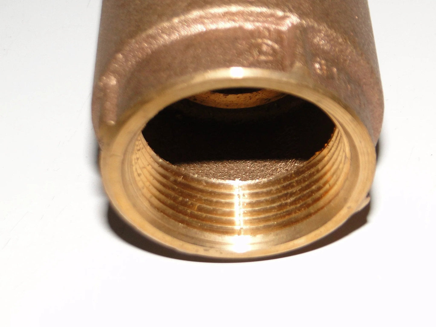 Close-up of No Lead Brass Check Valve 1 Inch NPT For Water Well Pump And Pressure Tank Installation 200 Lb Series Ideal For Jet Pumps Or Down The Well Bronze Finish CVNL100BS American Granby showing interior threading.