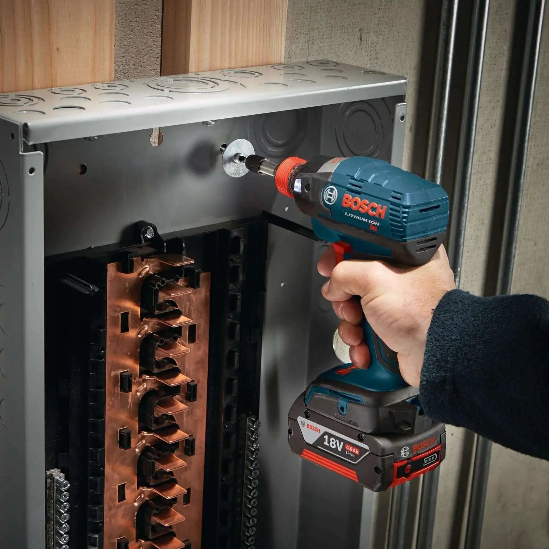 Person using Bosch 18V impact driver with Impact Tough Insert Bits Set For Heavy Duty Drilling Boss Grade Bosch 10 Pack 1 Inch Phillips And Square Number Two With Xtended Torsion Zone Precision Tips Heat Treated High Visibility Laser Etched Sleeve in power panel.