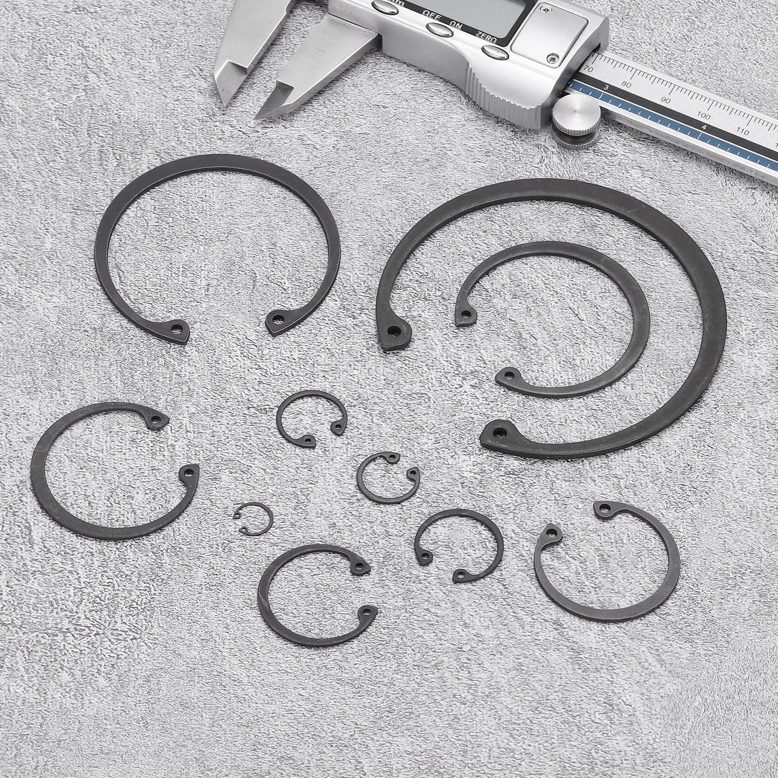 Internal Retaining Ring Circlip Set Two Pack, various sizes, with caliper on gray background, 65Mn steel, black oxide finish.