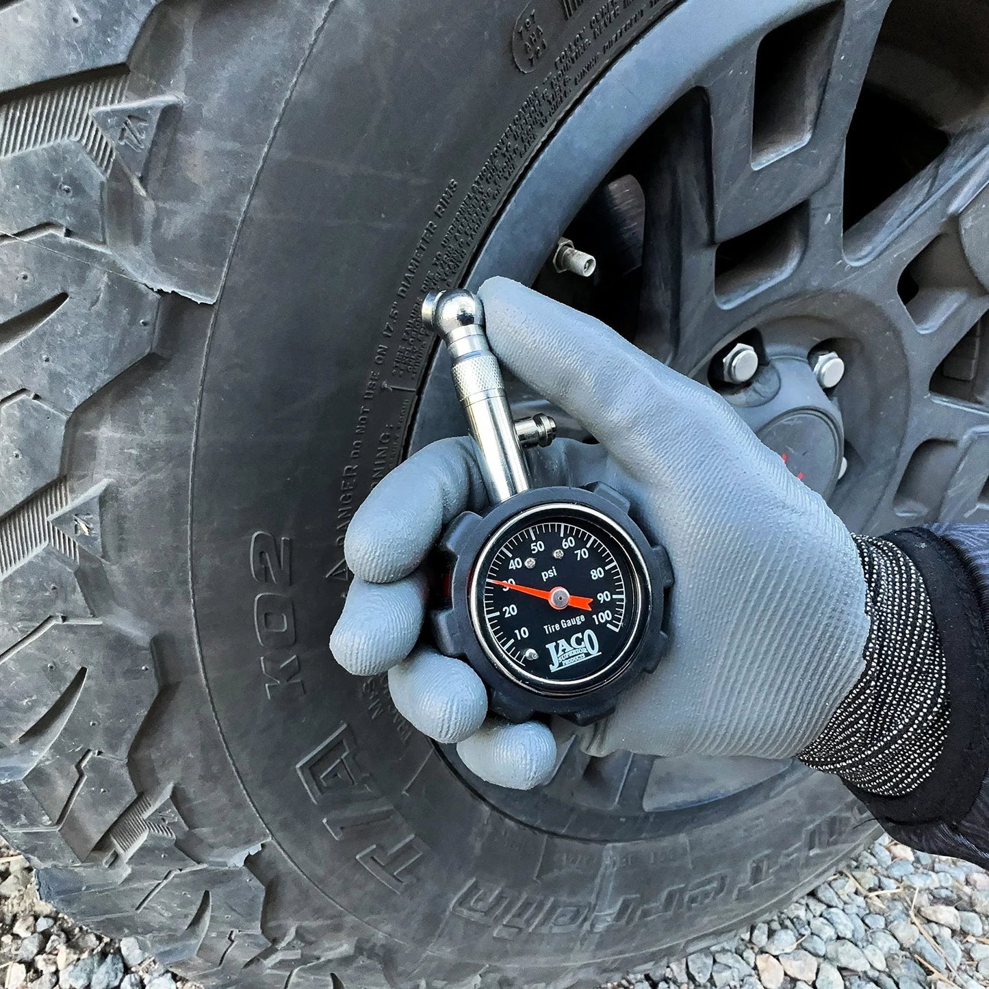 Person using Deluxe Tire Pressure Gauge For Cars And Bikes With 100 PSI Precision ANSI B40 1 Standard Calibrated Accuracy No Battery Required Durable Dual Layer Shock Guard JACO on car tire