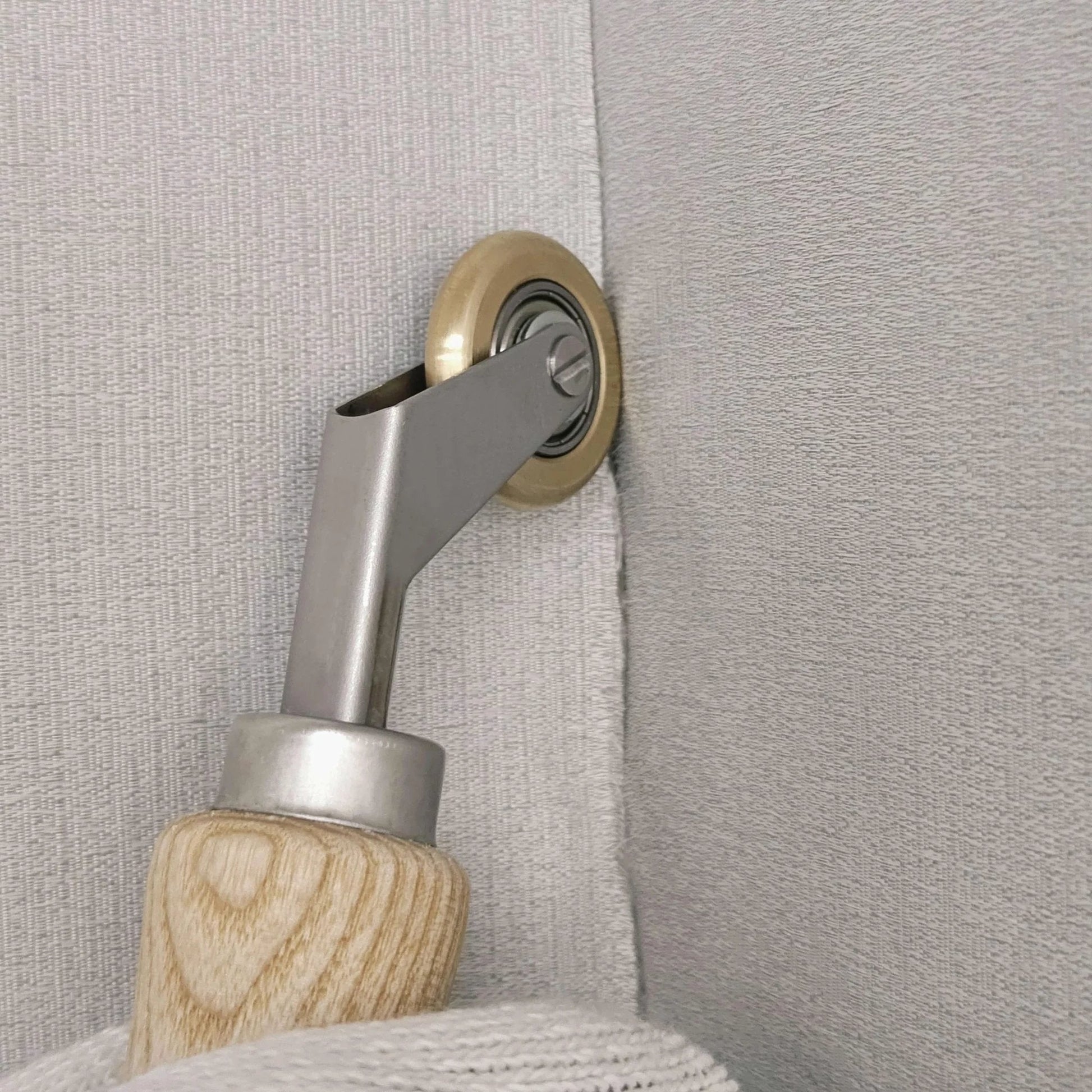 Pro Grade Welding Handheld Roller With 40mm Silicone Seam Roller And 6mm Brass Detail Penny Roller in use on wallpaper seam