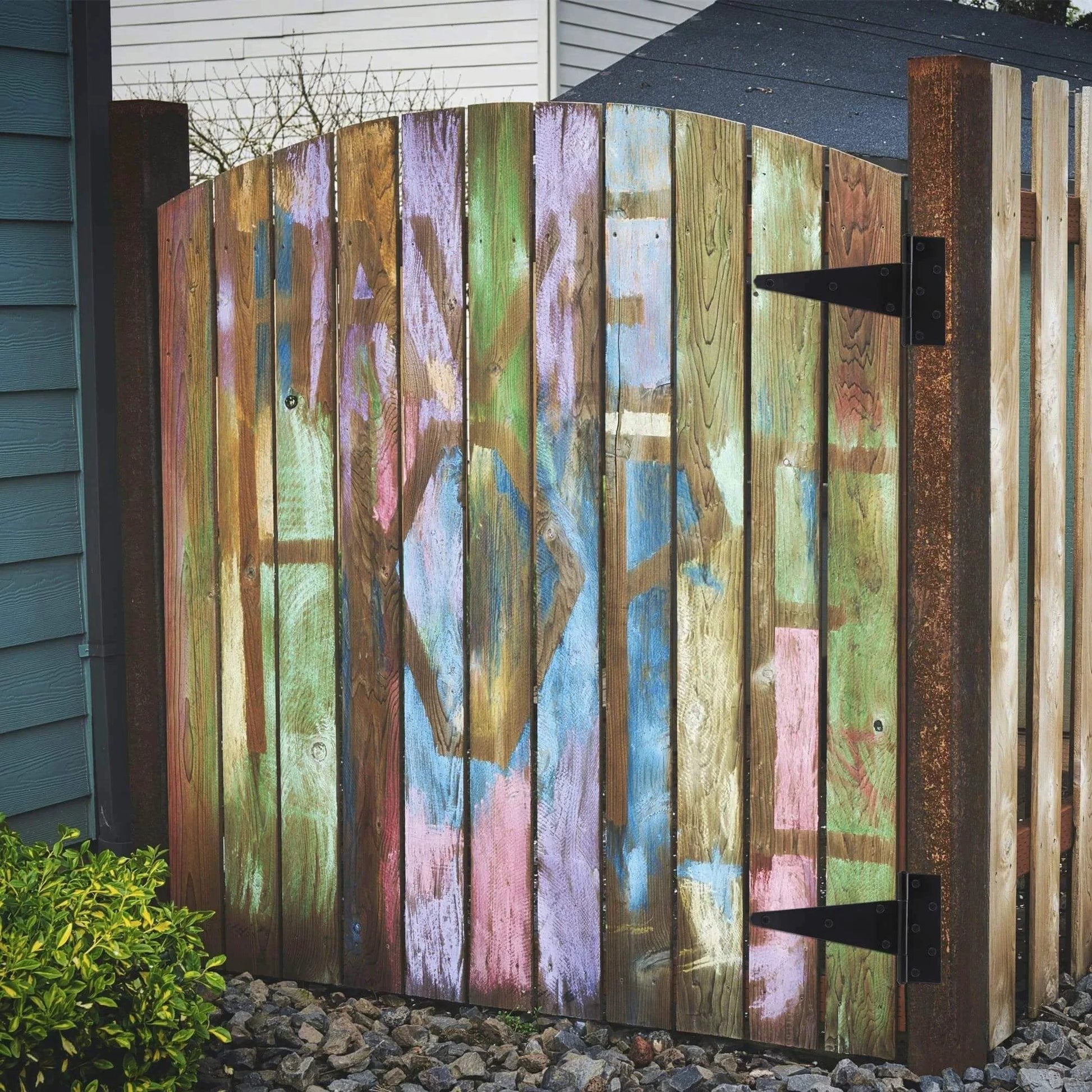 Wooden fence gate with colorful graffiti featuring 10 Inch T Strap Heavy Duty Door Hinges Black Tee Hinge For Wood Fences Gardens Barn