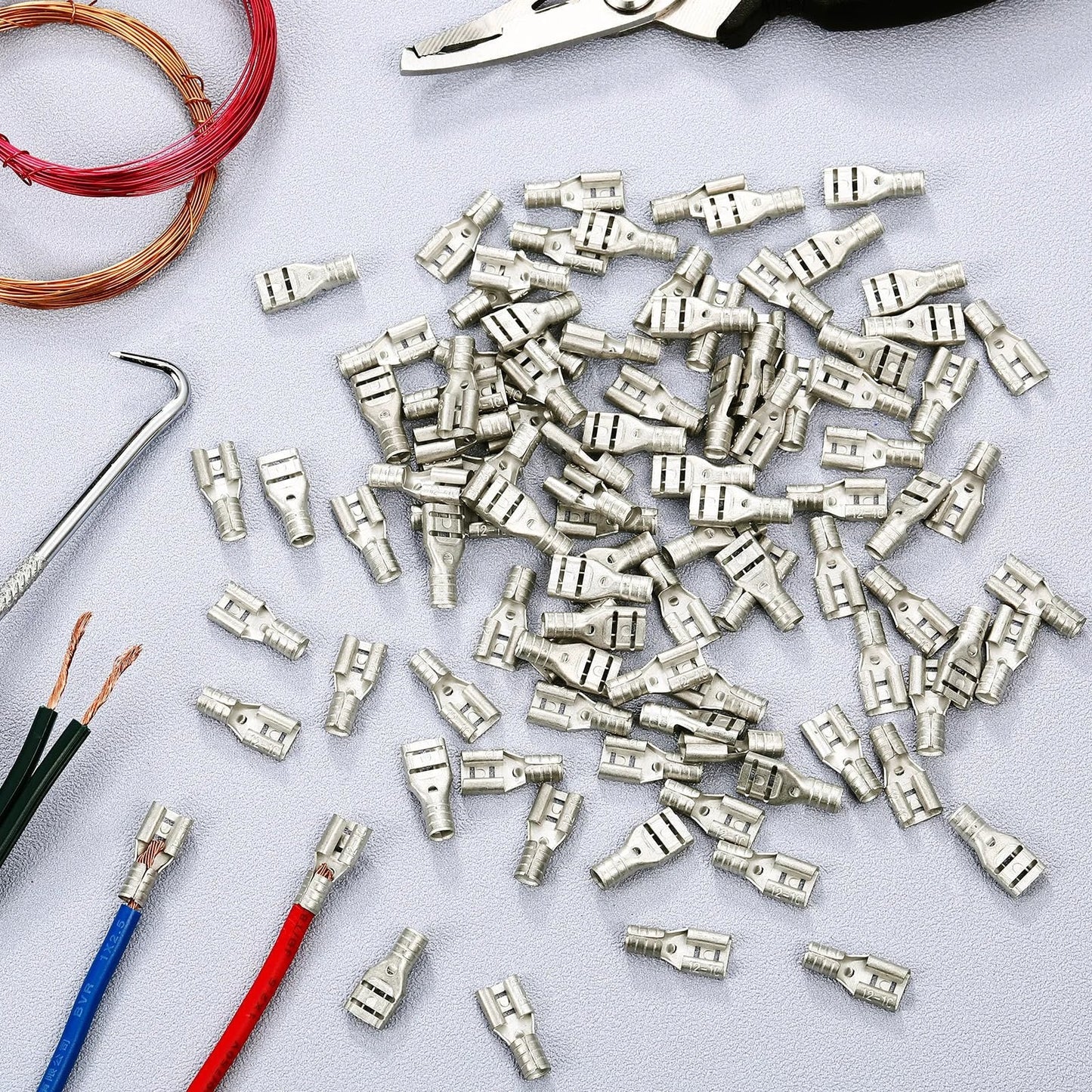 High Temperature Female Non Insulated Spade Connectors Pro Grade 100 Pack For 12 To 10 Gauge Quick Disconnect One Quarter Inch Female Tab Wire Splice Connectors For Strong Crimps In Electrical Terminals on a table with tools