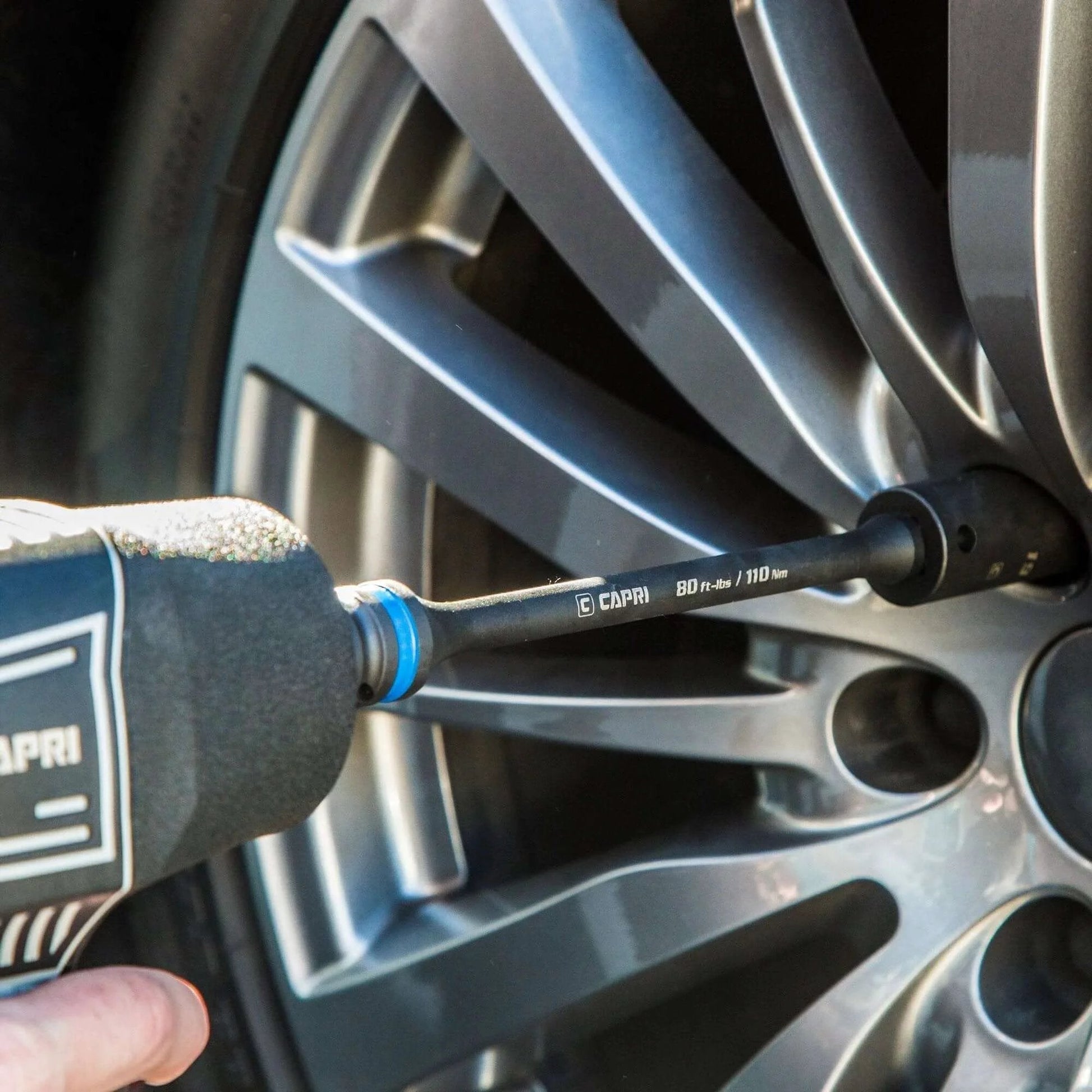 Capri Tools 1/2 in. Drive 120 ft. lbs. Torque Limiting Extension Bar in use with impact wrench on car wheel