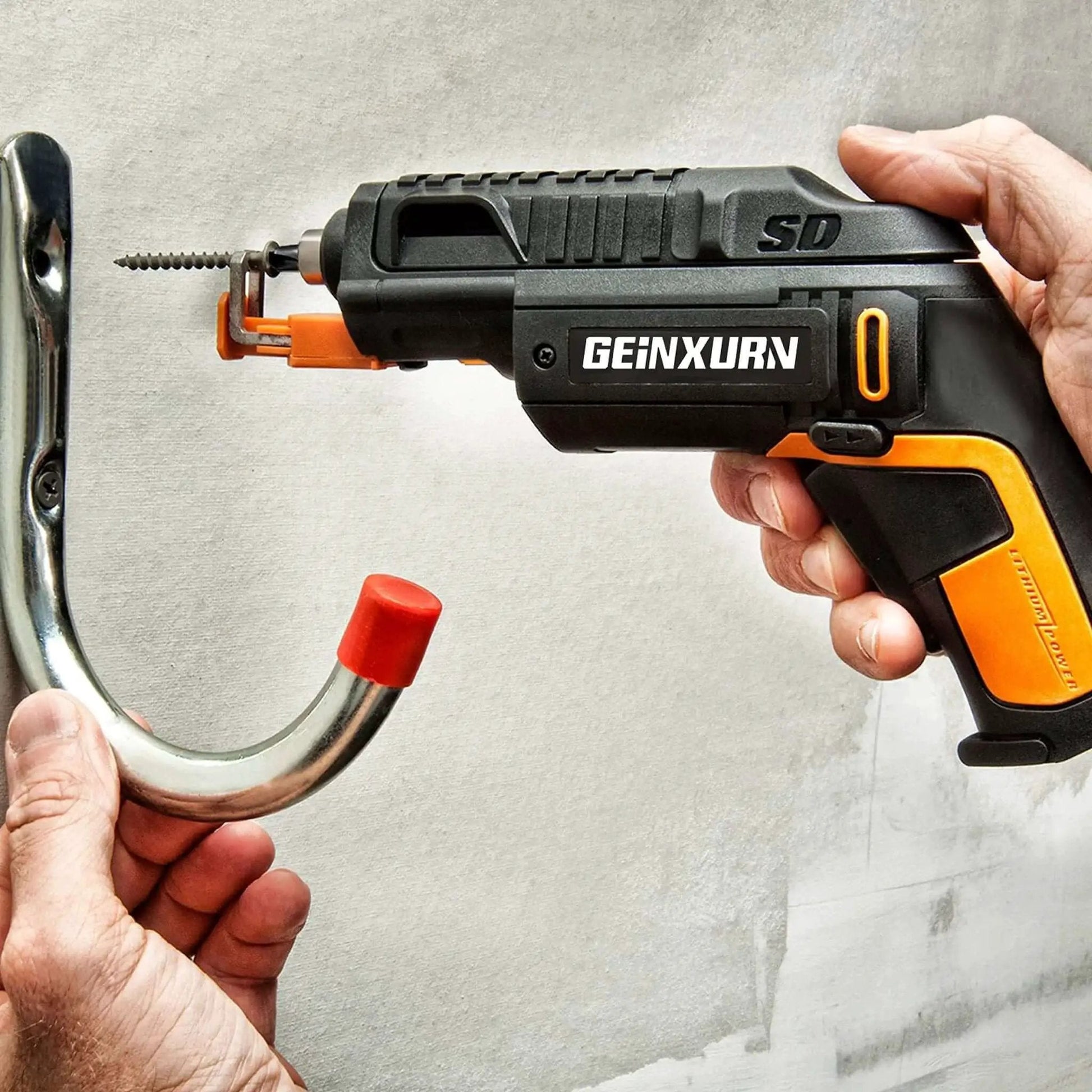 Man using GEINXURN tool to install hook with a screw in a wall.