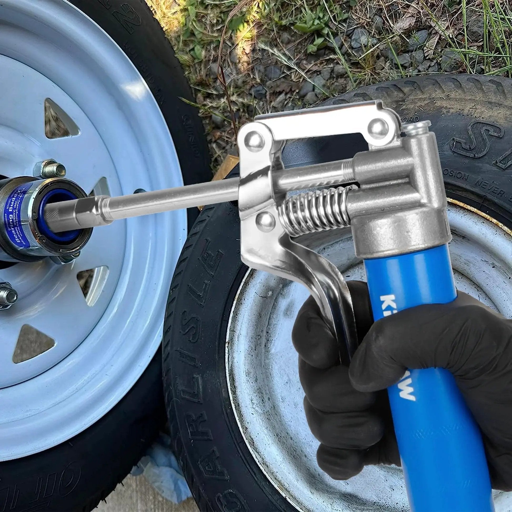 Person using Mini Grease Gun Kit 3000 PSI With Double 3oz Cartridges And 12 Inch Flex Hose Pro Grade Reinforced Coupler For Automotive And Marine