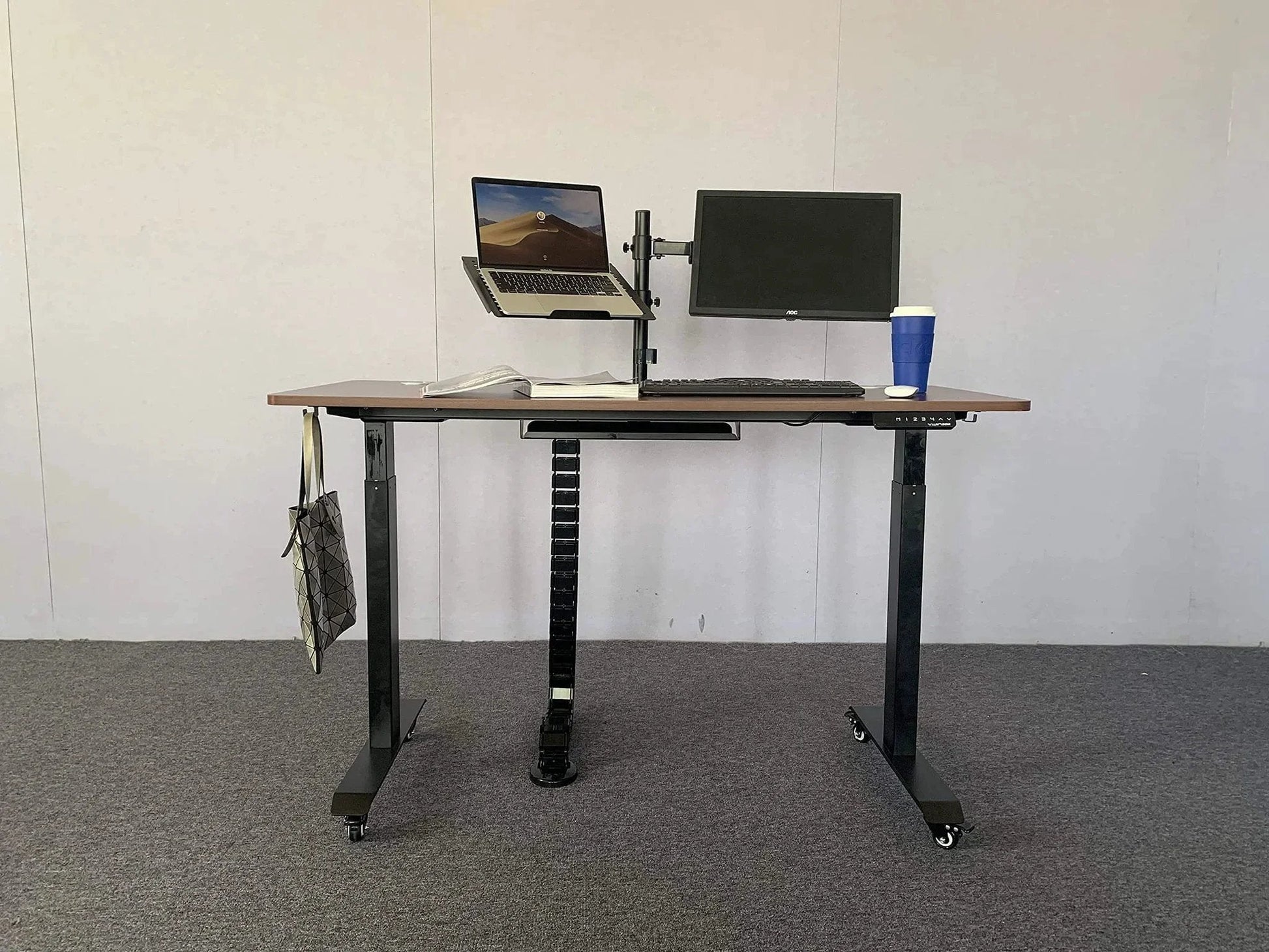 Standing desk on carpet with laptop, monitor, and 2 Inch M8 Threaded PU Swivel Casters Set Of 4 With Brakes For Standing Desks.