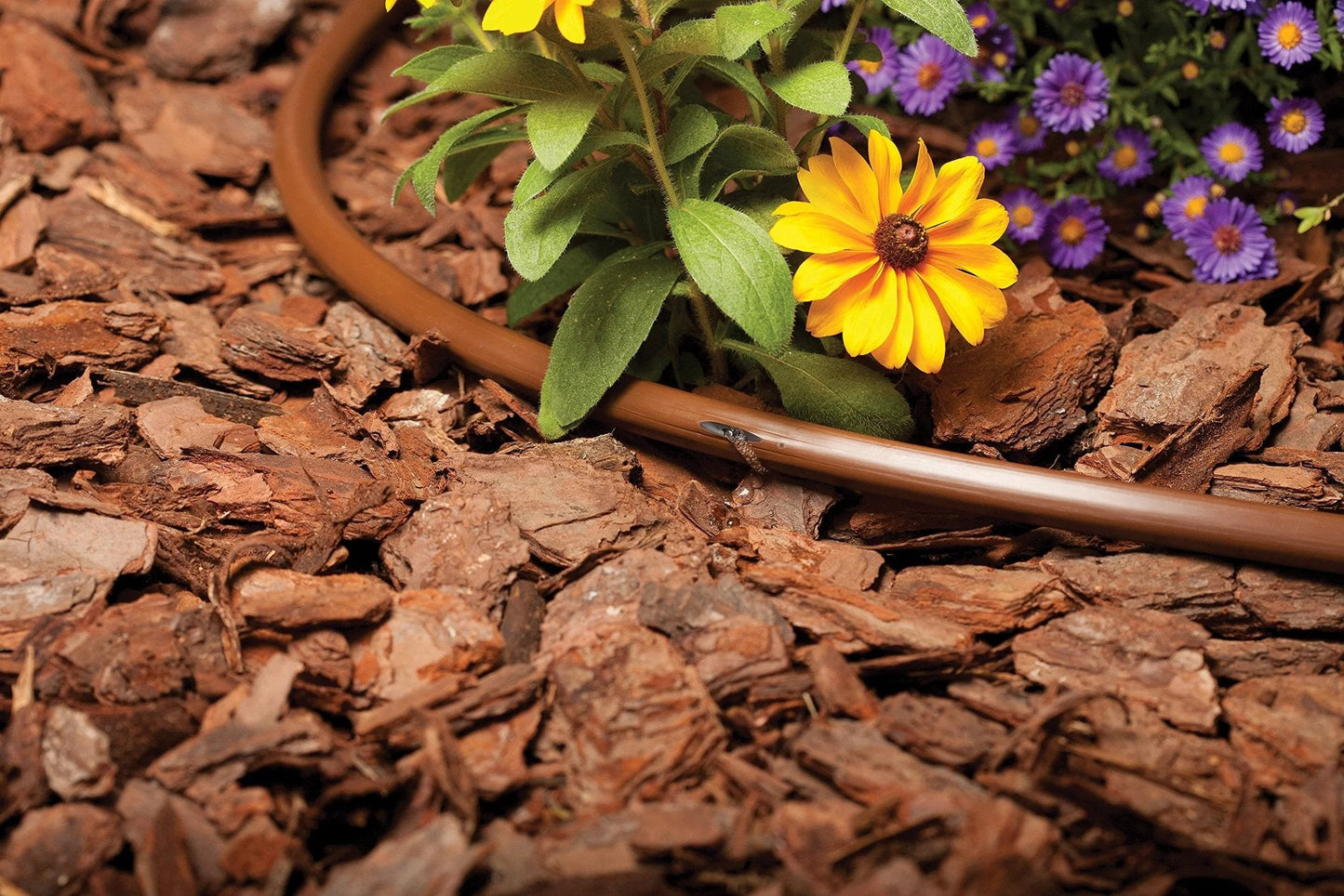 Drip Irrigation System with Pressure Compensating Emitter Tubing Kit half inch diameter 0.9 GPH emitters in garden bed mulch