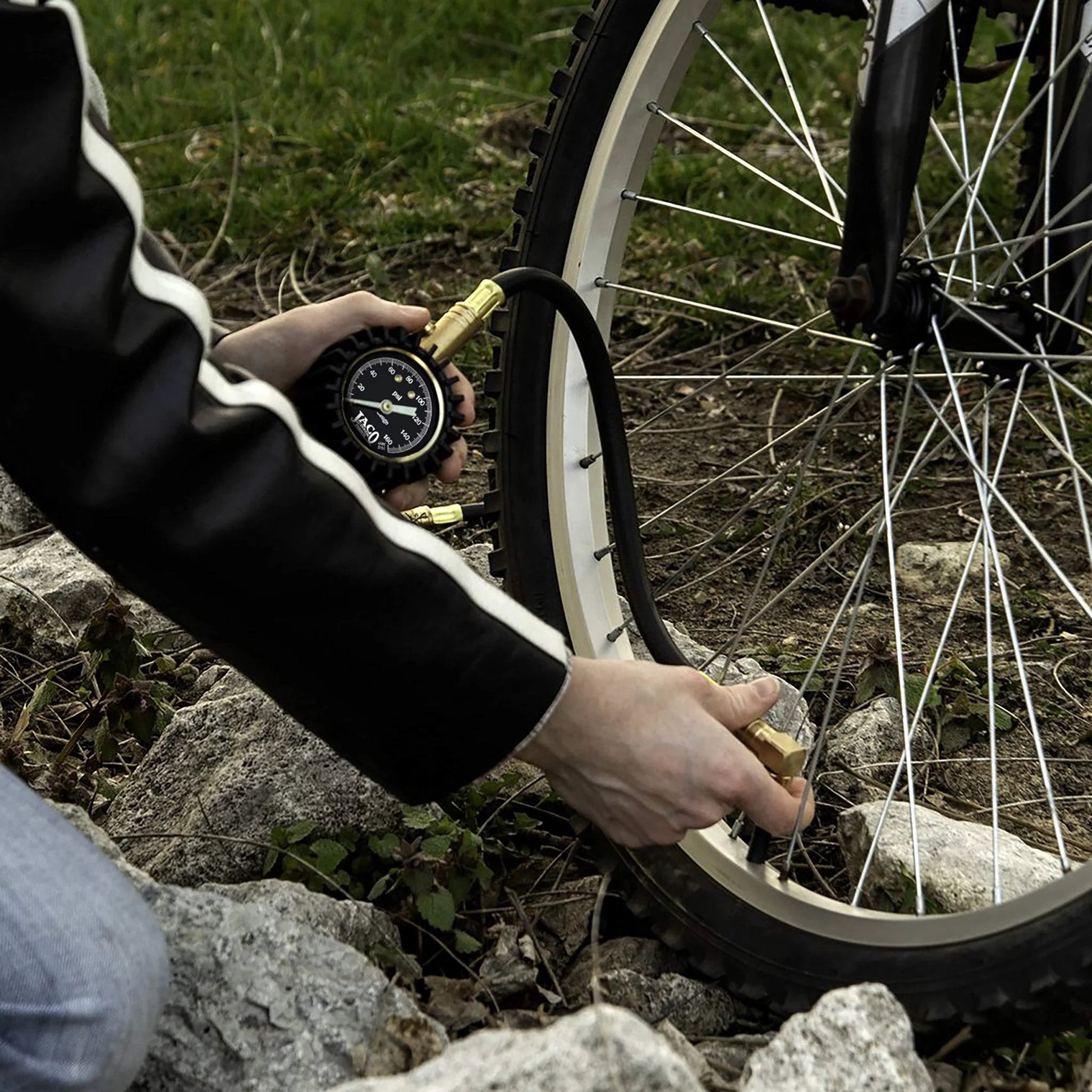 Person using Dual Air Chuck Tire Pressure Gauge Up To 160 PSI With Battery Free Accuracy, ANSI Certified And Mechanic Tested on a bike tire.