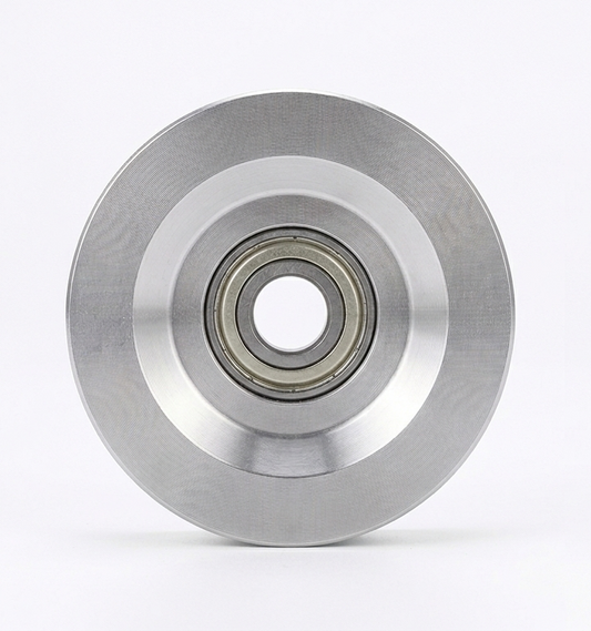 Two metal pulleys with bearings on a white background