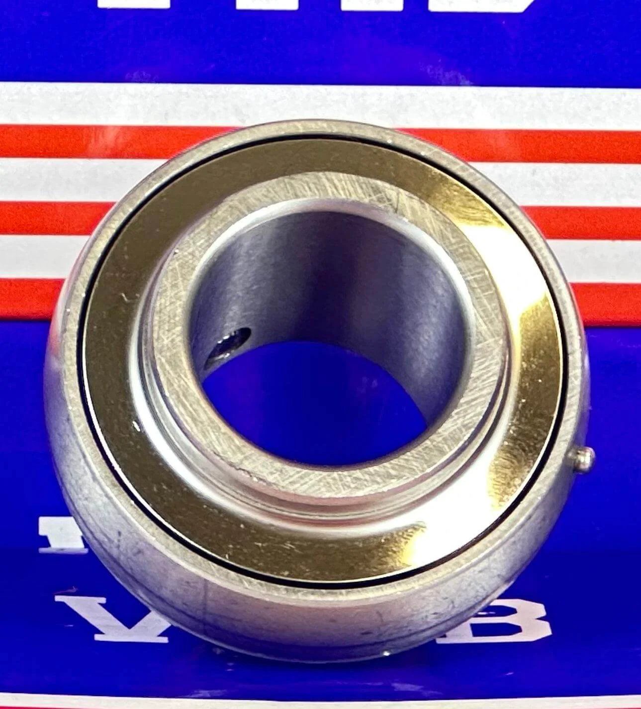 SSUC205-16 Stainless Steel Insert 1" Bore Ball Bearing on a blue and red background, showcasing its corrosion-resistant design.