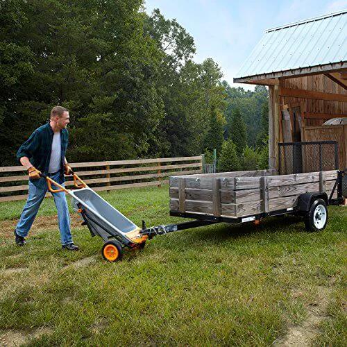 Man using 8 in 1 Heavy Duty Aerocart Garden Cart Wheelbarrow Dolly with Turbo Lift Design and Flat Free Tires to haul trailer