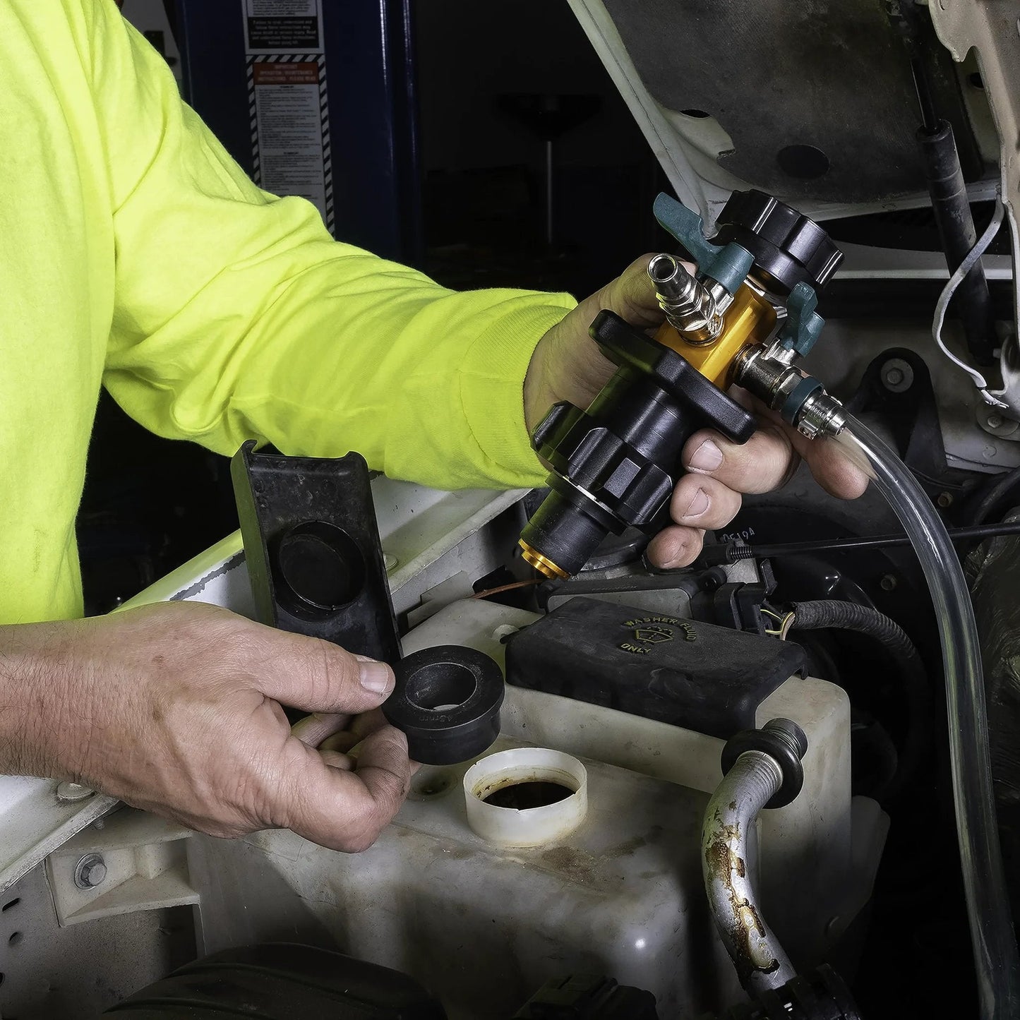 Person holding Air Evac Cooling System Refiller Kit, showing universal adapters for quick refill and air removal.