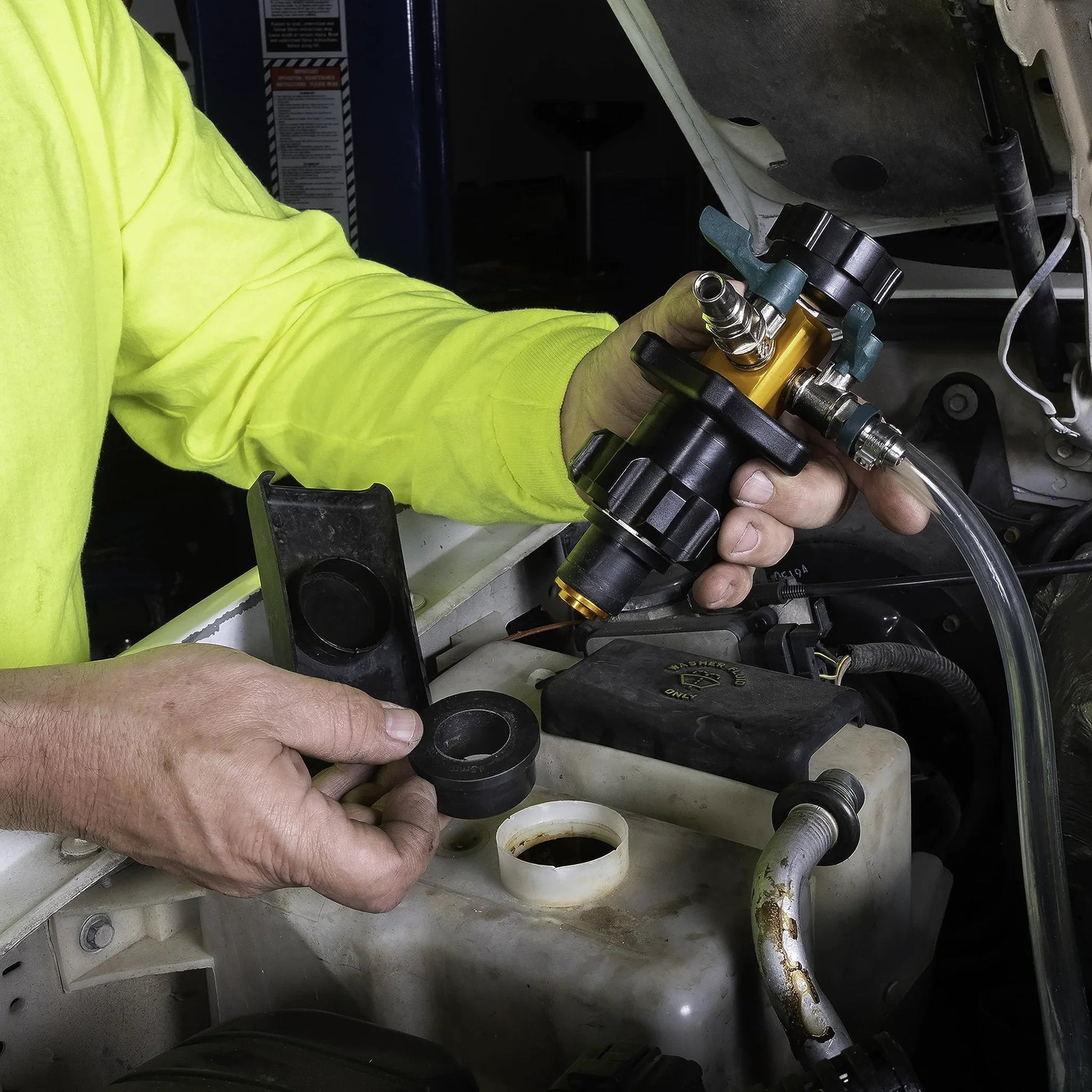 Person holding Air Evac Cooling System Refiller Kit, showing universal adapters for quick refill and air removal.