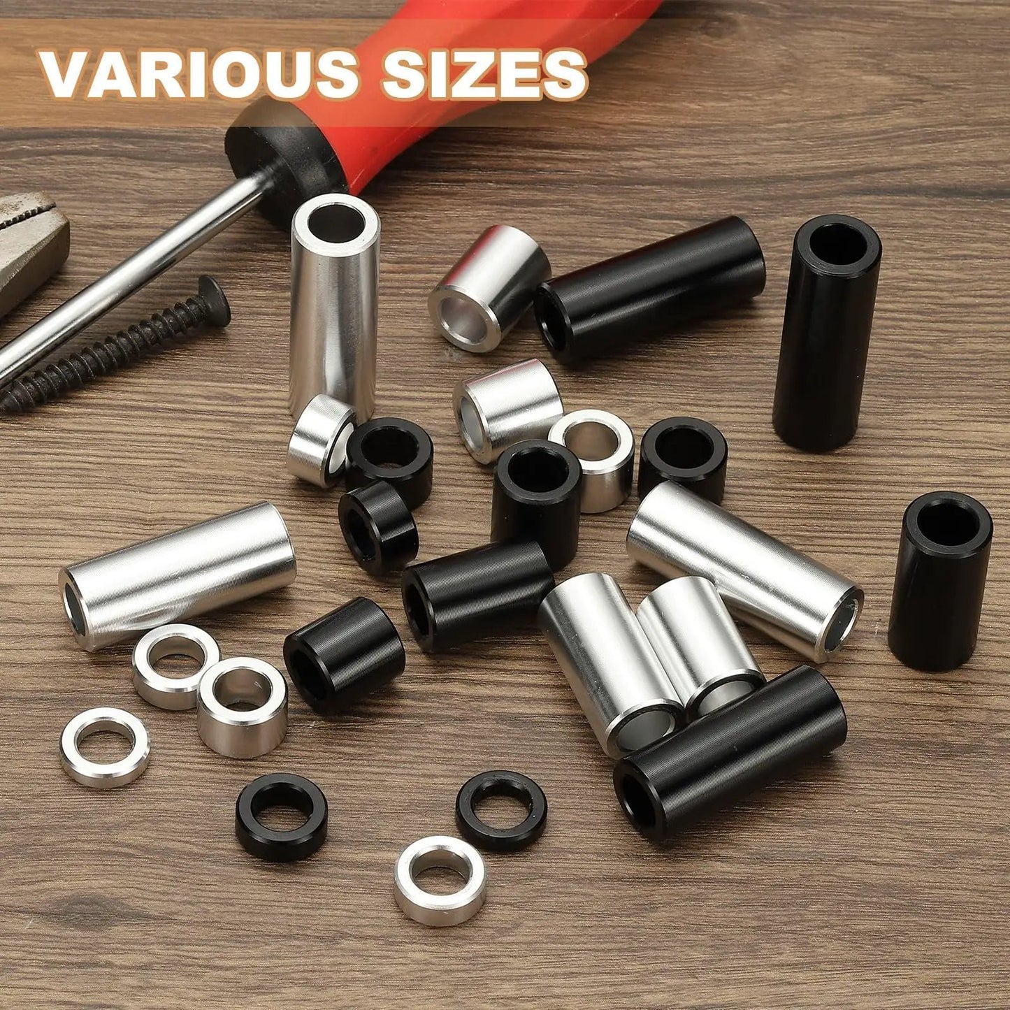 Assorted aluminum spacers in black and silver, unthreaded, various sizes, including 12 Pack Aluminum Spacers For Quarter Inch Screws Durable Aluminum Build One Quarter Inch Inner Diameter One Half Inch Outer Diameter One And A Half Inches Long Unthreaded Standoff Bushings Black Finish, with tools in background.