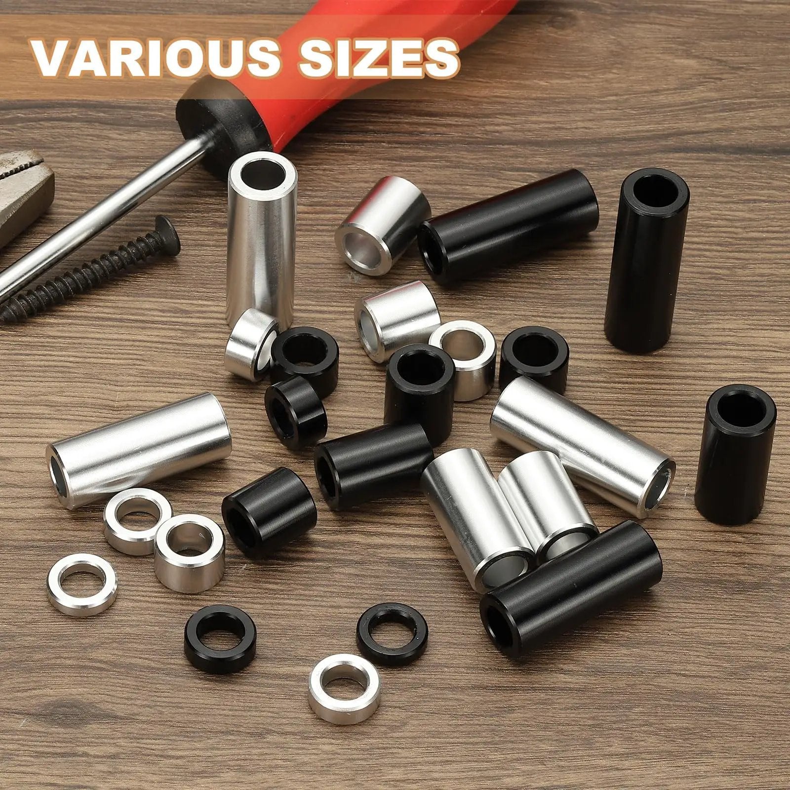 Assorted aluminum spacers in black and silver, unthreaded, various sizes, including 12 Pack Aluminum Spacers For Quarter Inch Screws Durable Aluminum Build One Quarter Inch Inner Diameter One Half Inch Outer Diameter One And A Half Inches Long Unthreaded Standoff Bushings Black Finish, with tools in background.