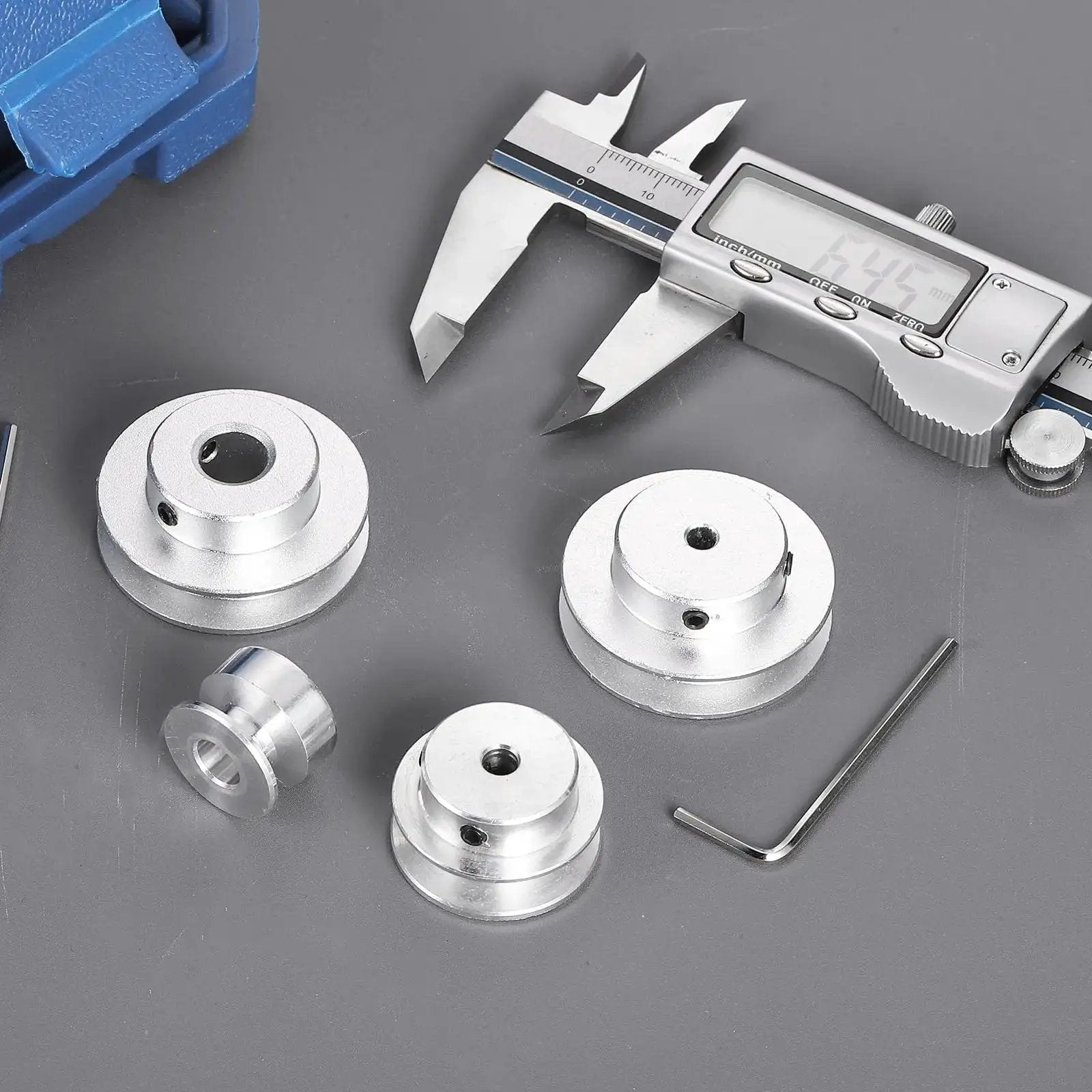 Aluminum single groove pulleys for 5–6 mm belts, 40 mm OD, 4 mm bore, hex wrench included, shown with caliper for size reference and setup ease.