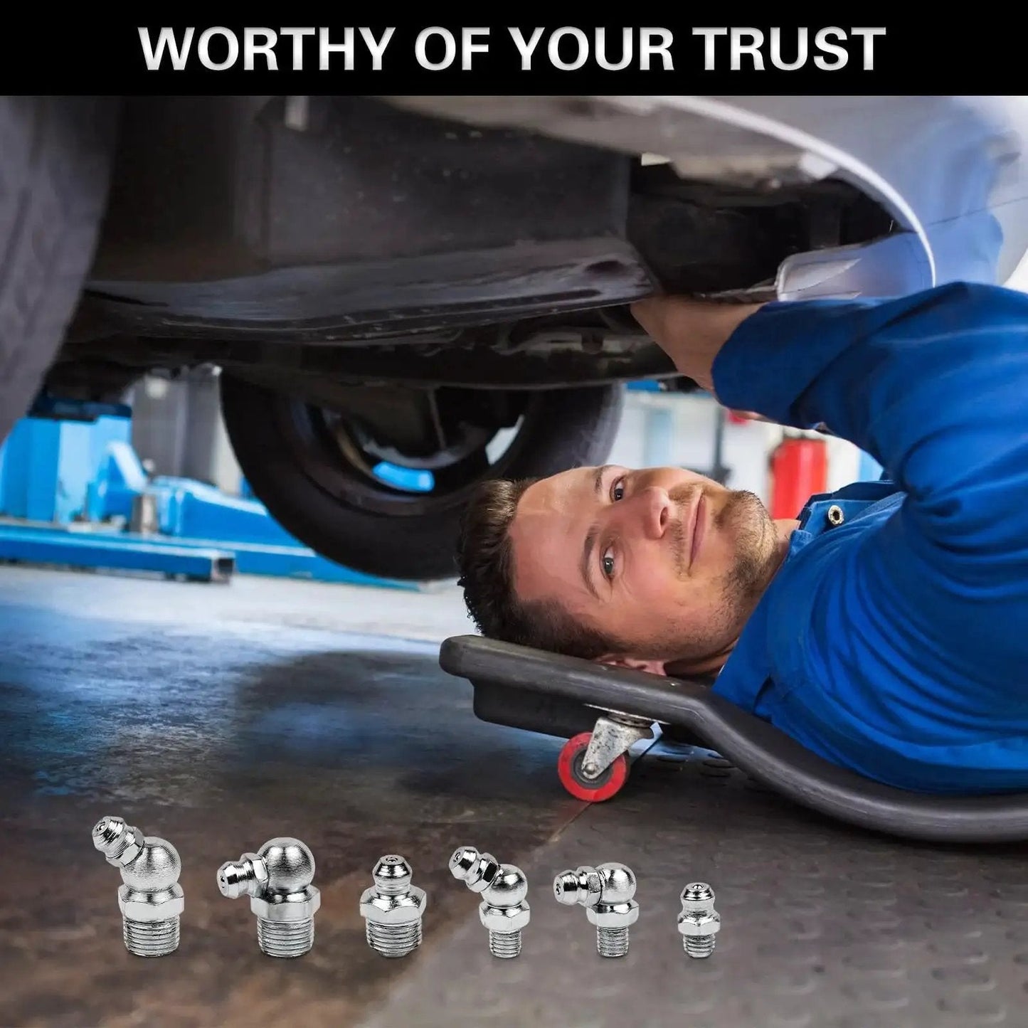 60 Piece Grease Fittings Kit With One Quarter Inch And One Eighth Inch BSP Threads Featuring Ninety Degree Forty Five Degree And Straight Angles For Automotive Tractors And Industrial Machinery Maintenance Heavy Duty Lubrication Kit displayed in a workshop with mechanic under a car.
