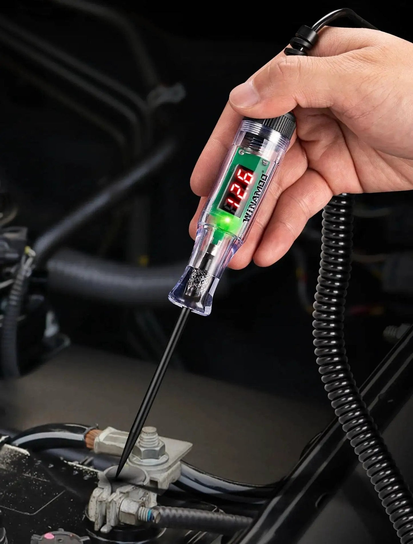 Compact automotive test light with a 3 to 48V LED digital display used for battery checks, showing 12.3V, dual polarity LEDs visible.