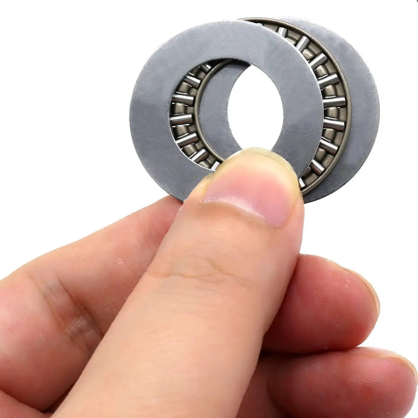 Close-up of Heavy Duty Workhorse Thrust Needle Roller Bearing Set With Washers AXK2035 held in hand, showing precision steel cage.