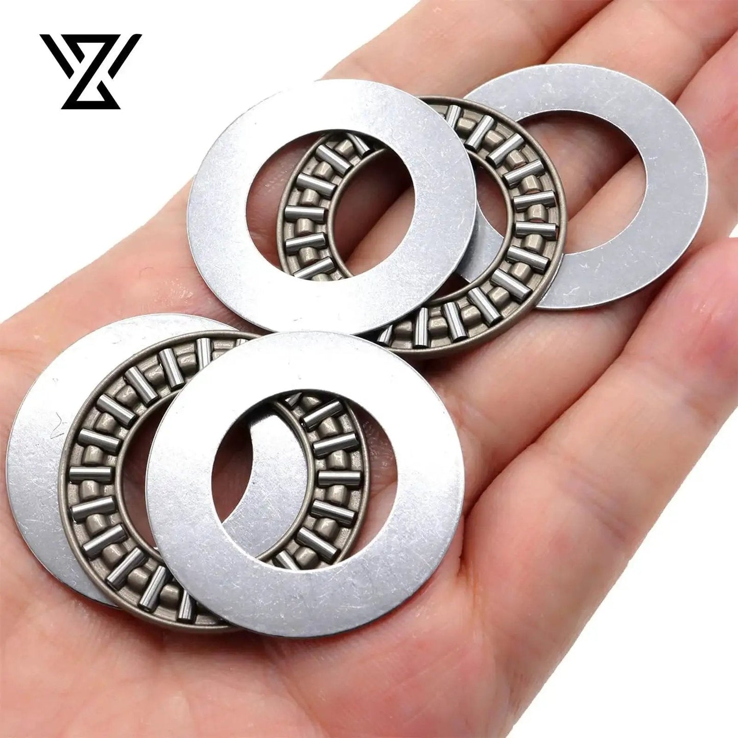 Hand holding Thrust Needle Roller Bearing Set AXK2035 with Washers for lawn tractor steering, showcasing alloy steel and compact design.