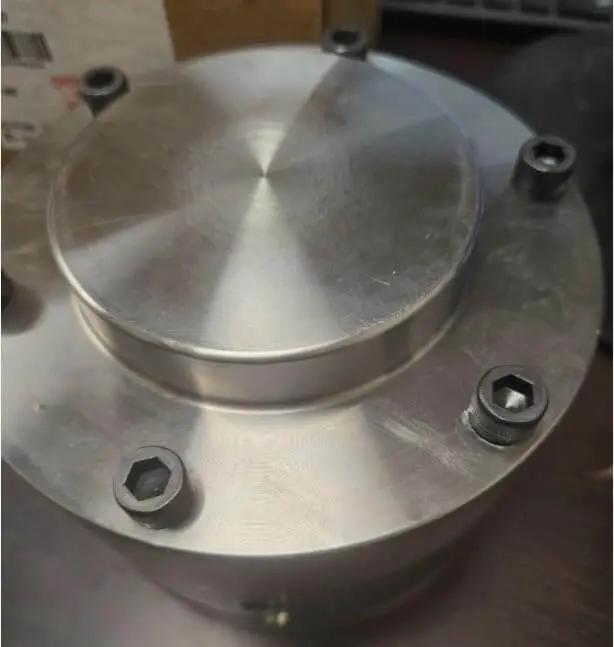 Front view of the Workhorse Backstop J4507 For Mechanical Power Transmission And Industrial Automation With Smooth Operation And Ball And Roller Bearing Tapered Design For Easy Installation And Maintenance Rexnord Falk, metal unit with screws.