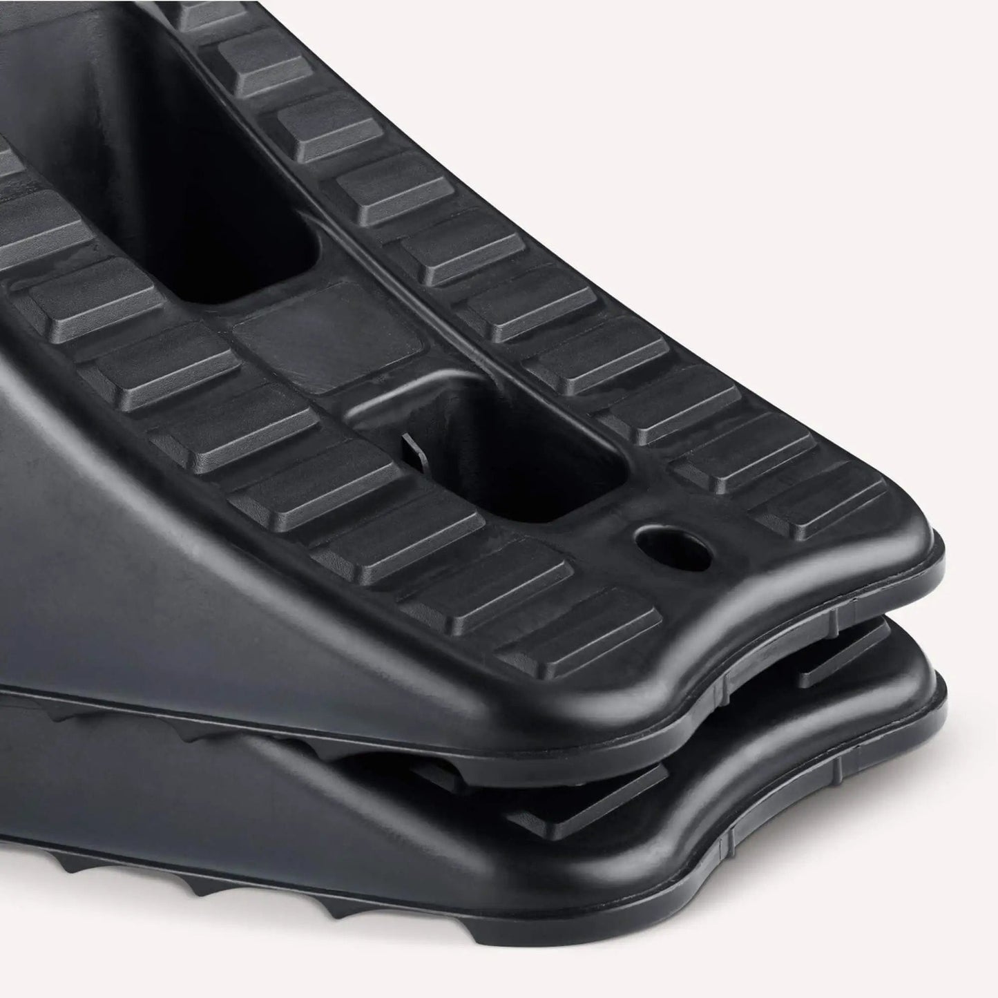 Close-up of Garage Ready Automotive Wheel Chocks 2 Pack for Secure Vehicle Parking in Home Garages, black plastic, nesting design.