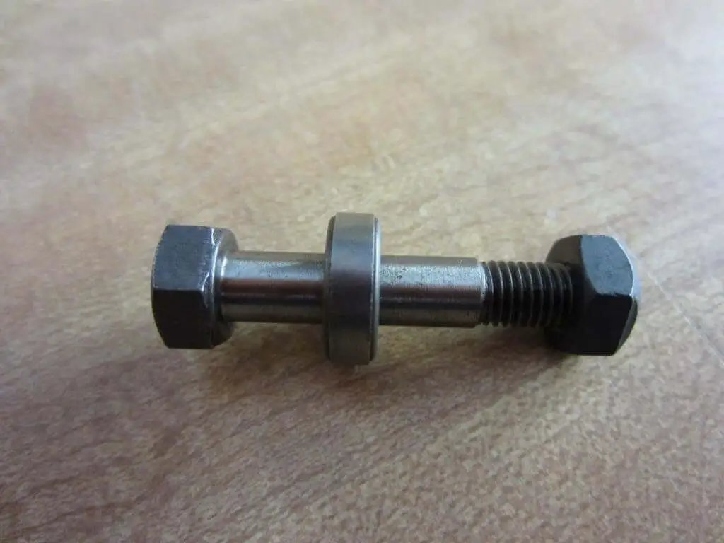 Bolt Kit With Nut And Spacer For One Quarter Inch Shaft Diameter Head Size Seven Sixteenths Inch Total Length One And Five Eighths Inches Rexnord 012914 PKIT SNS 162 STL, shown on wood surface.