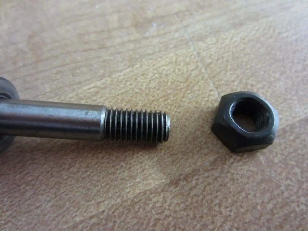 Close-up of Bolt Kit With Nut And Spacer For One Quarter Inch Shaft Diameter Head Size Seven Sixteenths Inch Total Length One And Five Eighths Inches Rexnord 012914 PKIT SNS 162 STL showing the threaded section and nut.