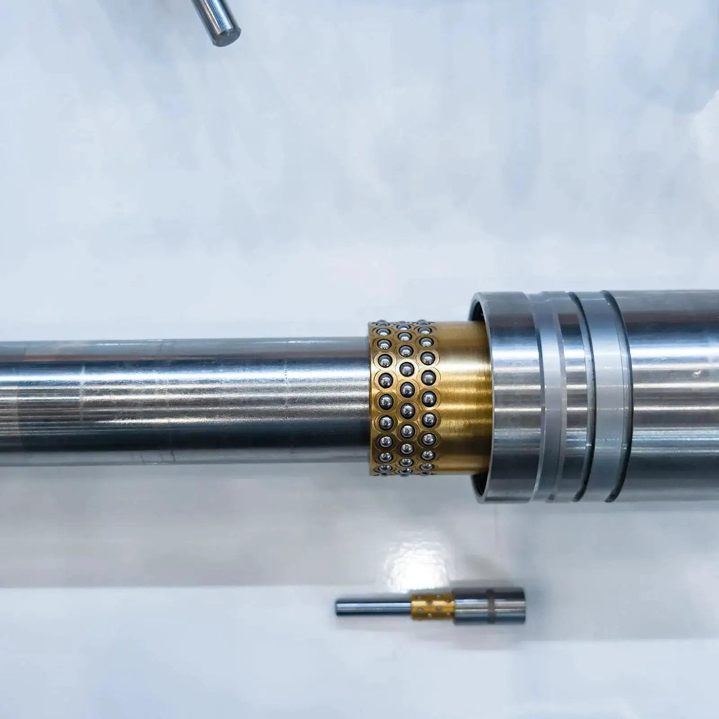 Five Piece Sleeve Bearings With One Quarter Inch Bore And Five Sixteenth Inch Outer Diameter Three Quarter Inch Length installed on a shaft
