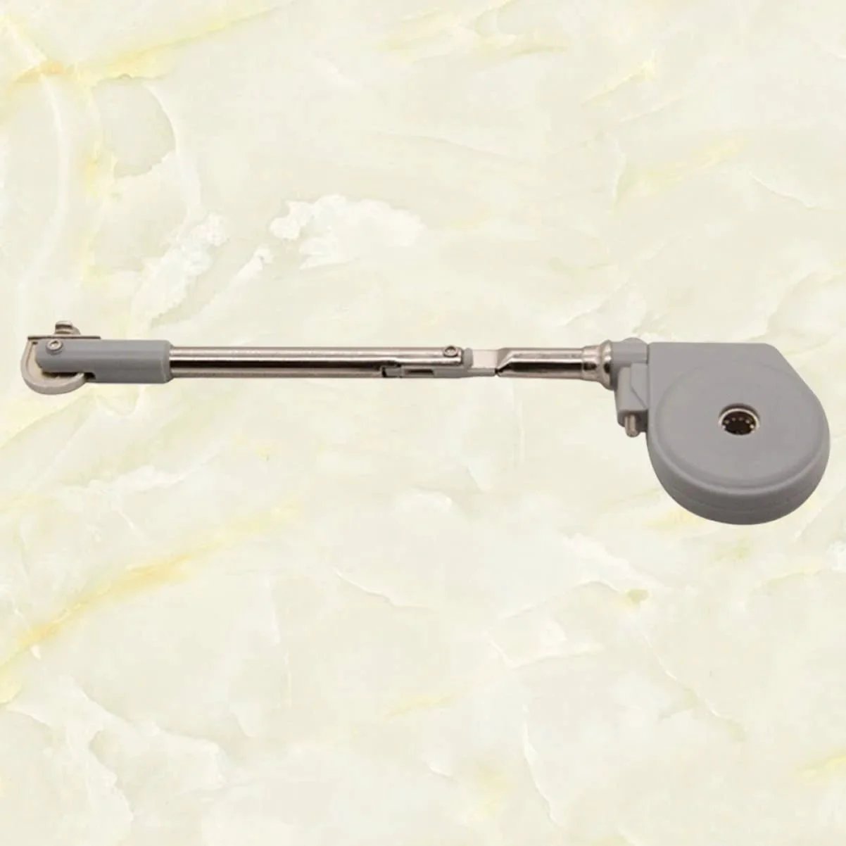 Drop Down Short Cabinet Door Gas Strut Hydraulic Gas Spring with satin silver finish on marble background