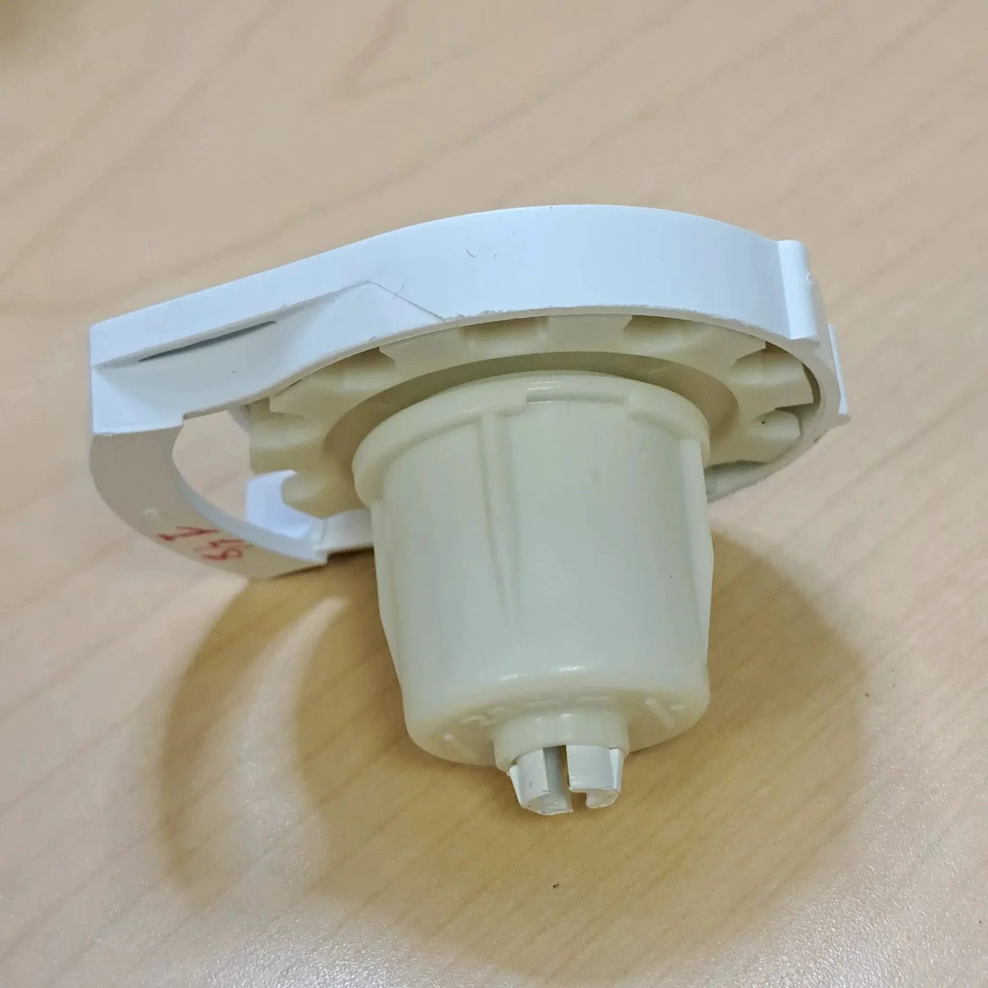 Side view of Clutch R Series with Bead Stopper (White, R8-1 1/8" Tube) showing multipspring design on a wooden surface.